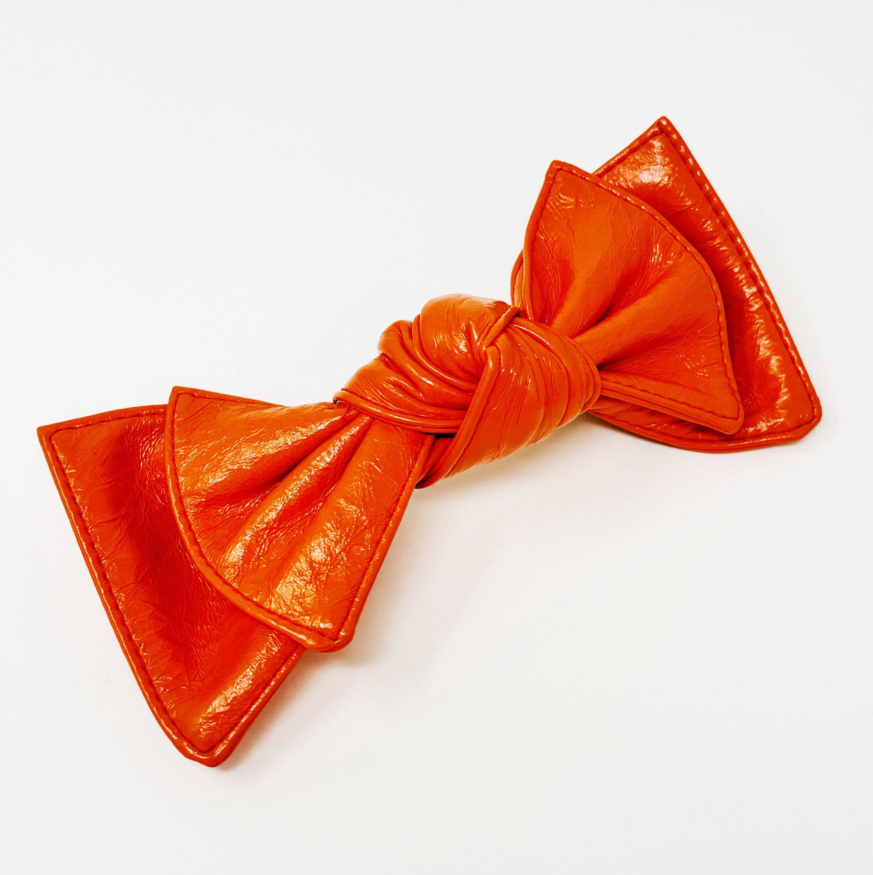 Patent Double Bow Hair Clip in faux patent leather, featuring a stylish double bow design, perfect for various hairstyles.