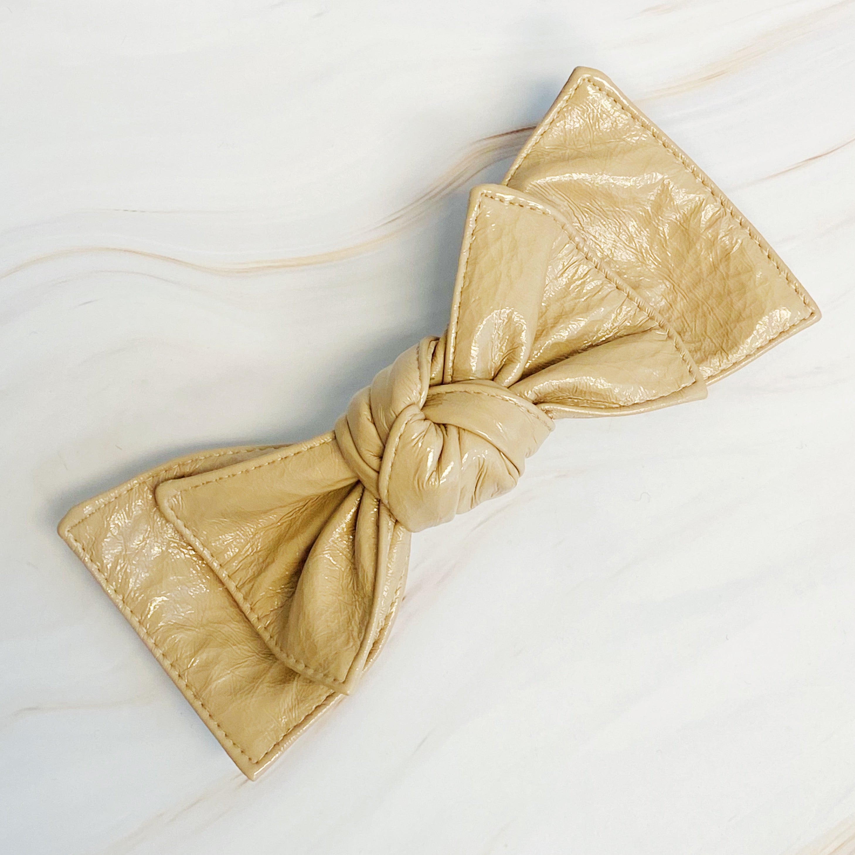 Patent Double Bow Hair Clip in faux patent leather, featuring a stylish double bow design, perfect for various hairstyles.