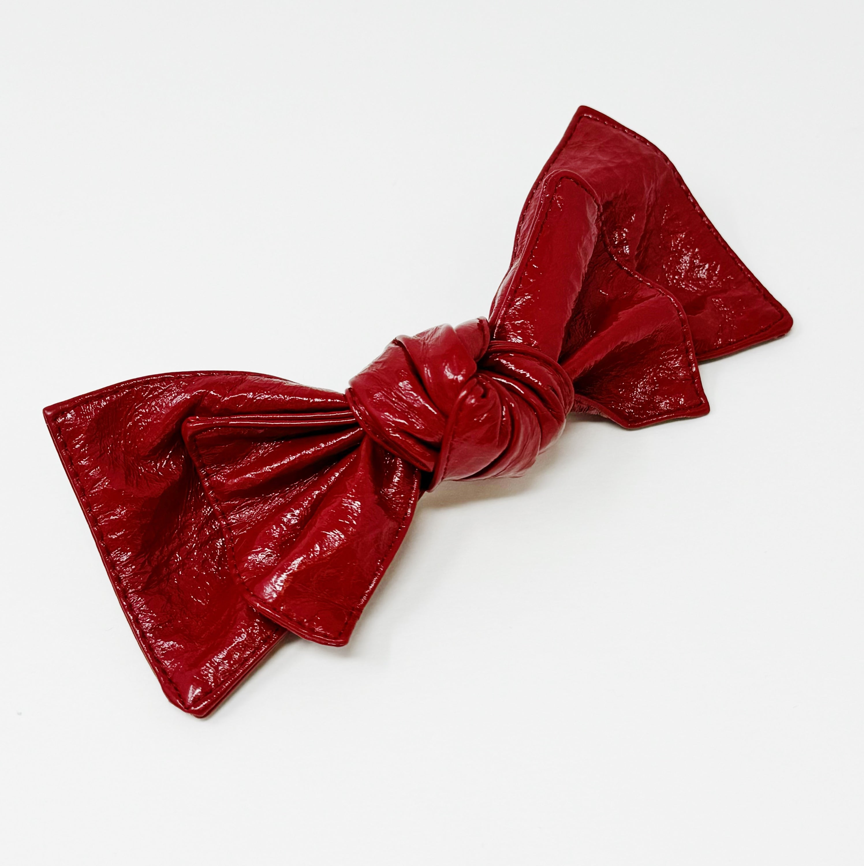 Patent Double Bow Hair Clip in faux patent leather, featuring a stylish double bow design, perfect for various hairstyles.