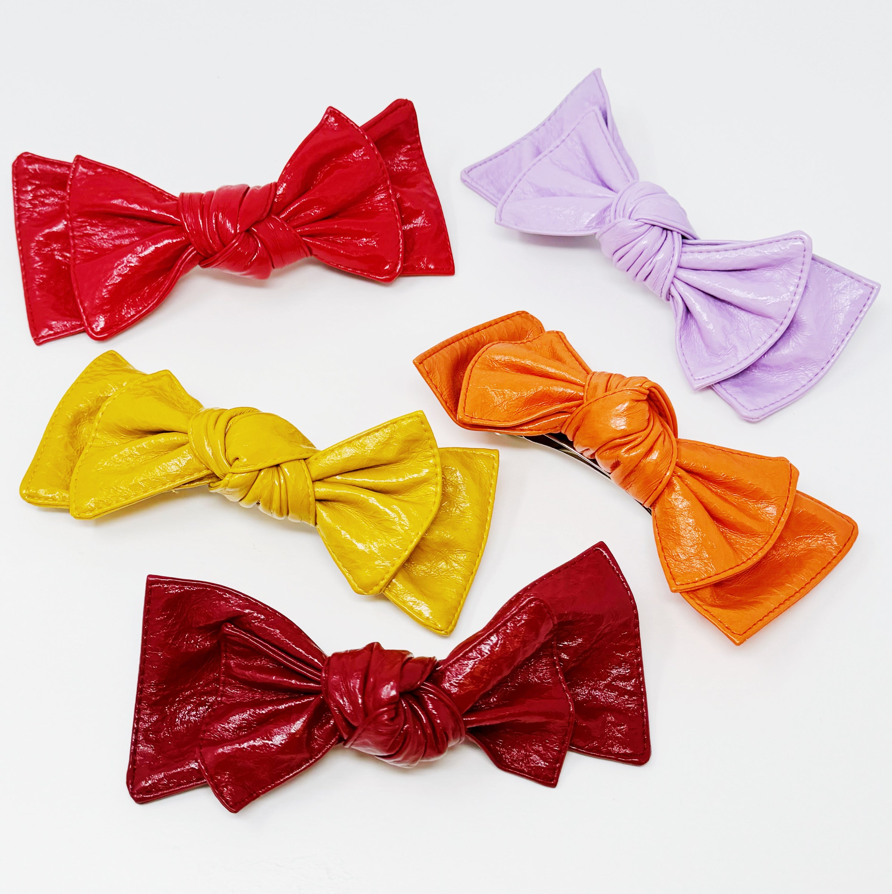 Patent Double Bow Hair Clip in faux patent leather, featuring a stylish double bow design, perfect for various hairstyles.