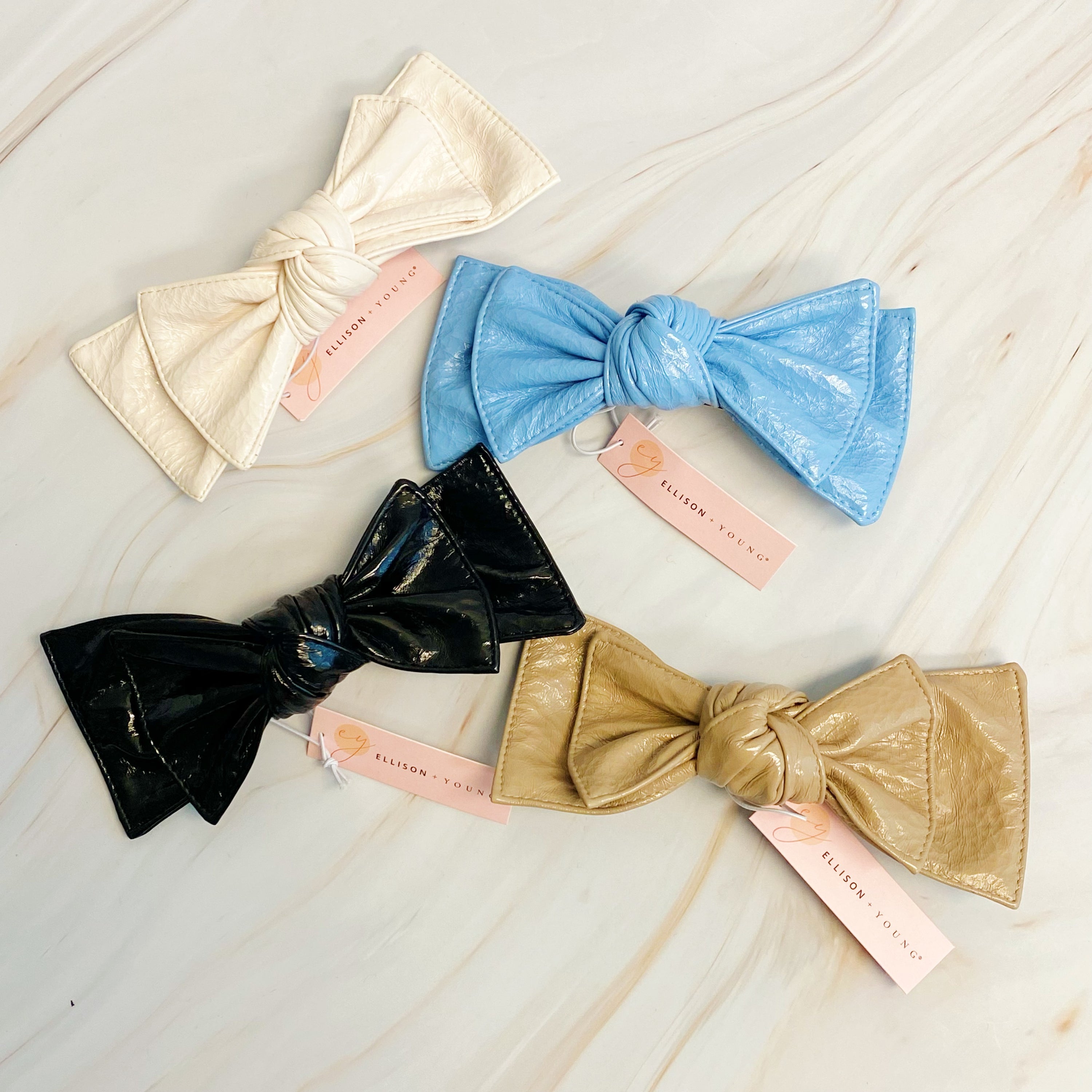 Patent Double Bow Hair Clip in faux patent leather, featuring a stylish double bow design, perfect for various hairstyles.