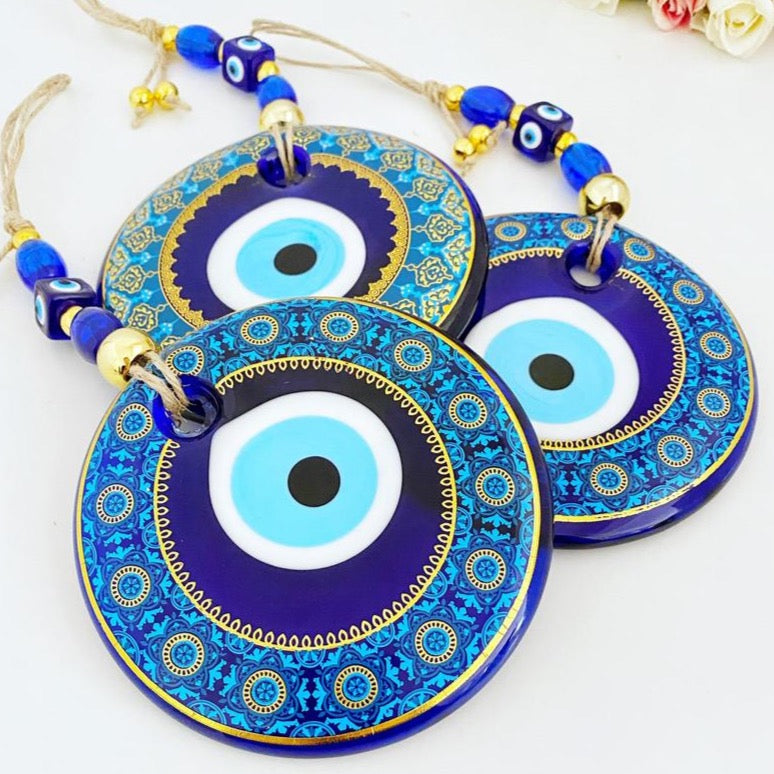 A beautifully crafted 13cm patterned Evil Eye wall hanging featuring vibrant blue hues and intricate designs, symbolizing protection and good fortune.