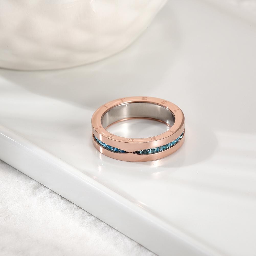 PAVÉ Statement Ring featuring blue CZ stones in a rose gold setting, elegantly displayed in a gift box.