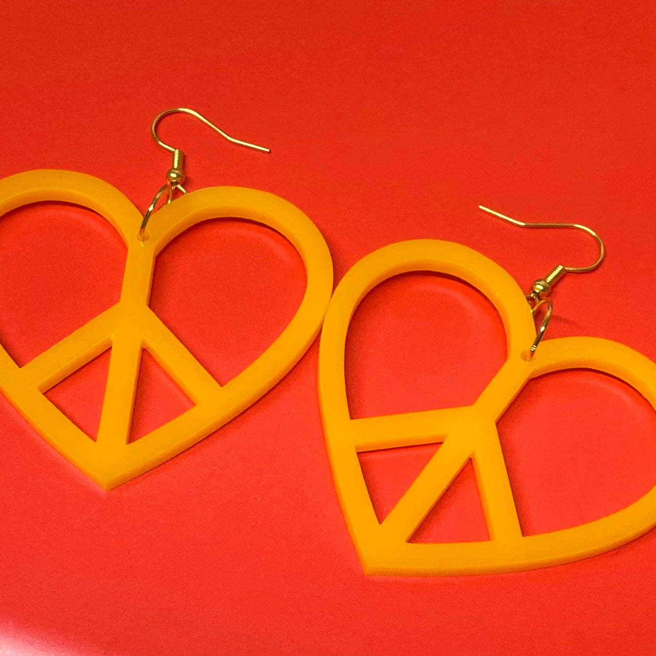 Colorful Peace Heart Earrings made from laser-cut acrylic, showcasing a heart shape with a peace symbol design.