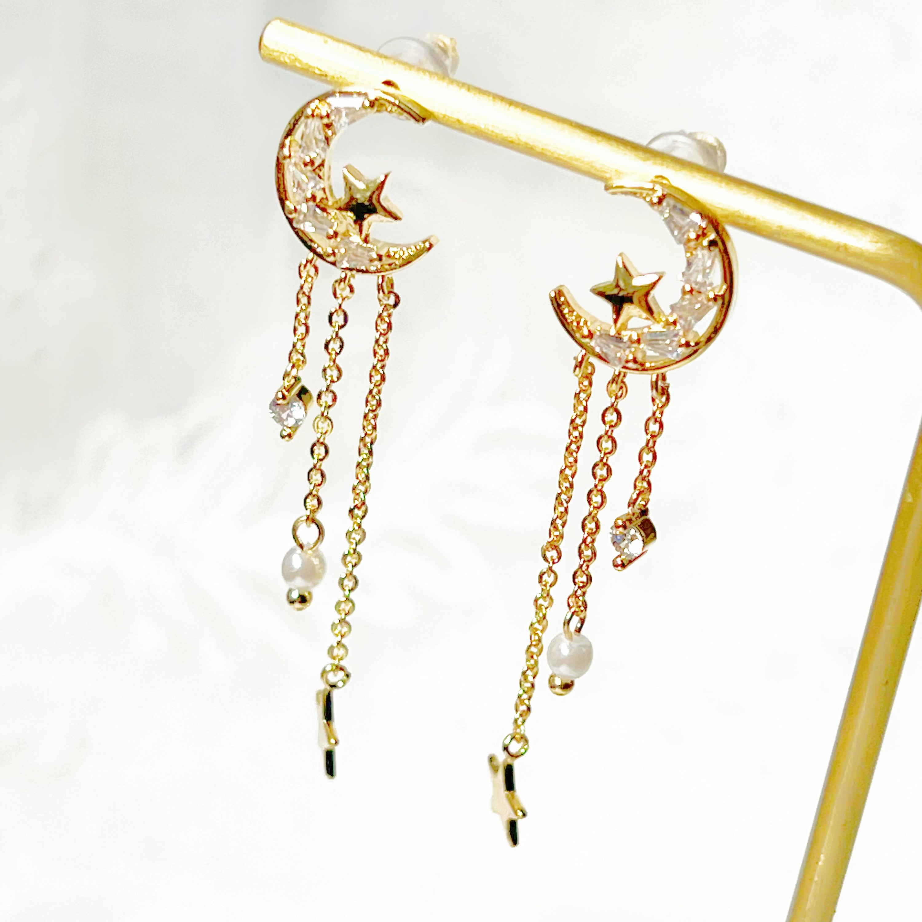 Elegant Peaceful Night Moon and Stars Drop Earrings featuring zircon crystals and gold plated bronze base.