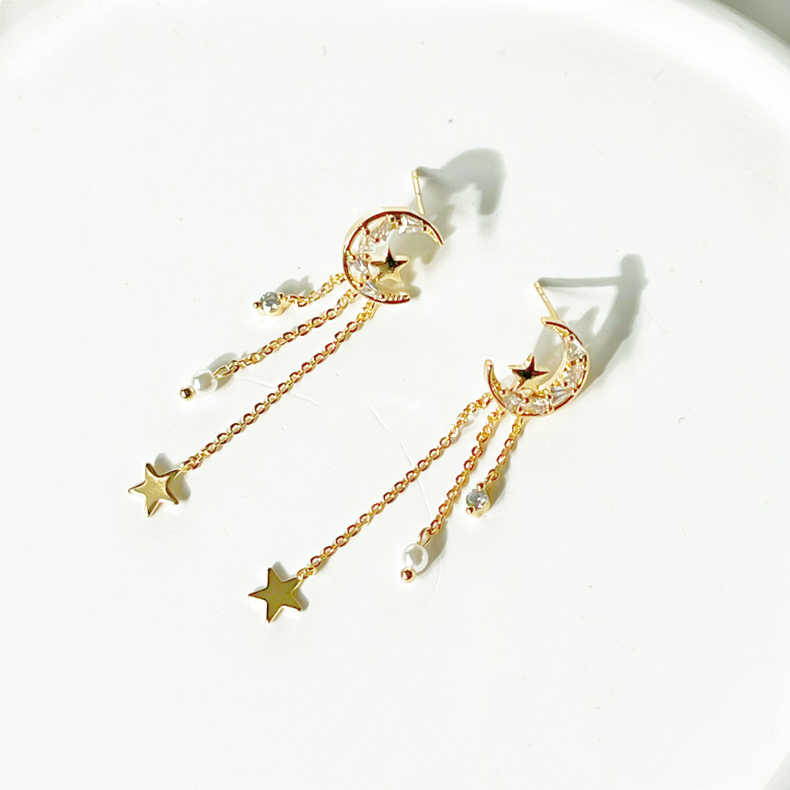 Elegant Peaceful Night Moon and Stars Drop Earrings featuring zircon crystals and gold plated bronze base.