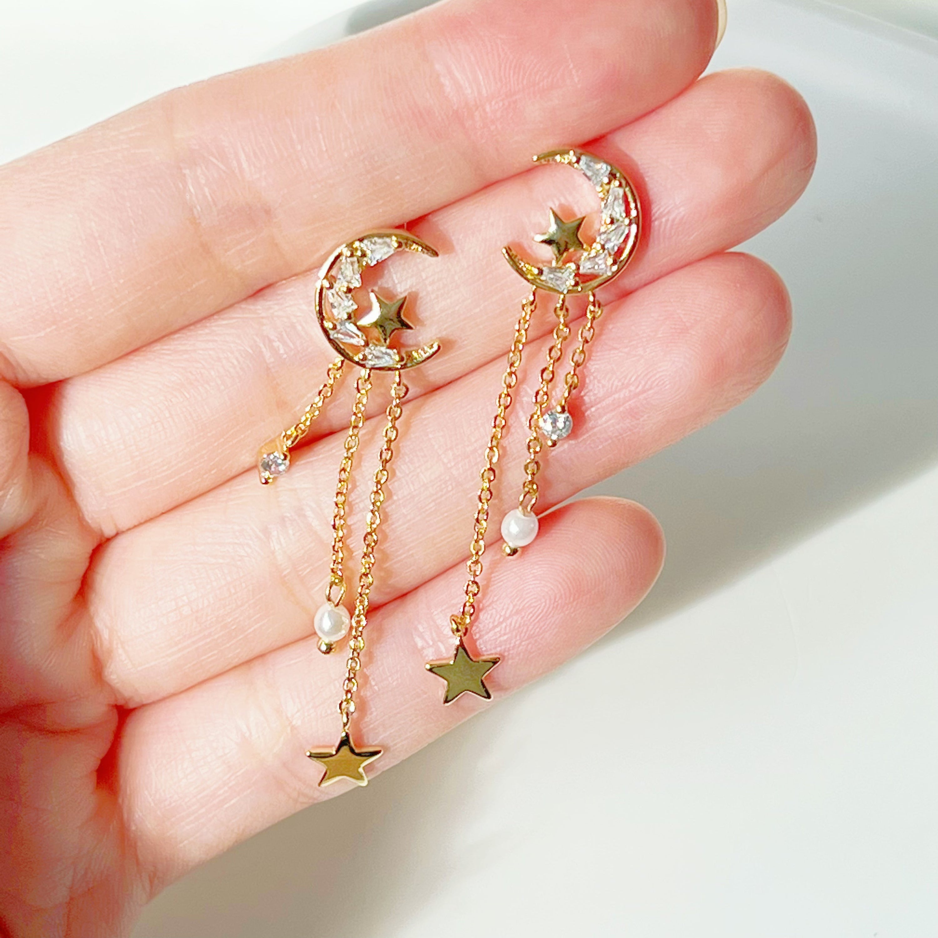 Elegant Peaceful Night Moon and Stars Drop Earrings featuring zircon crystals and gold plated bronze base.