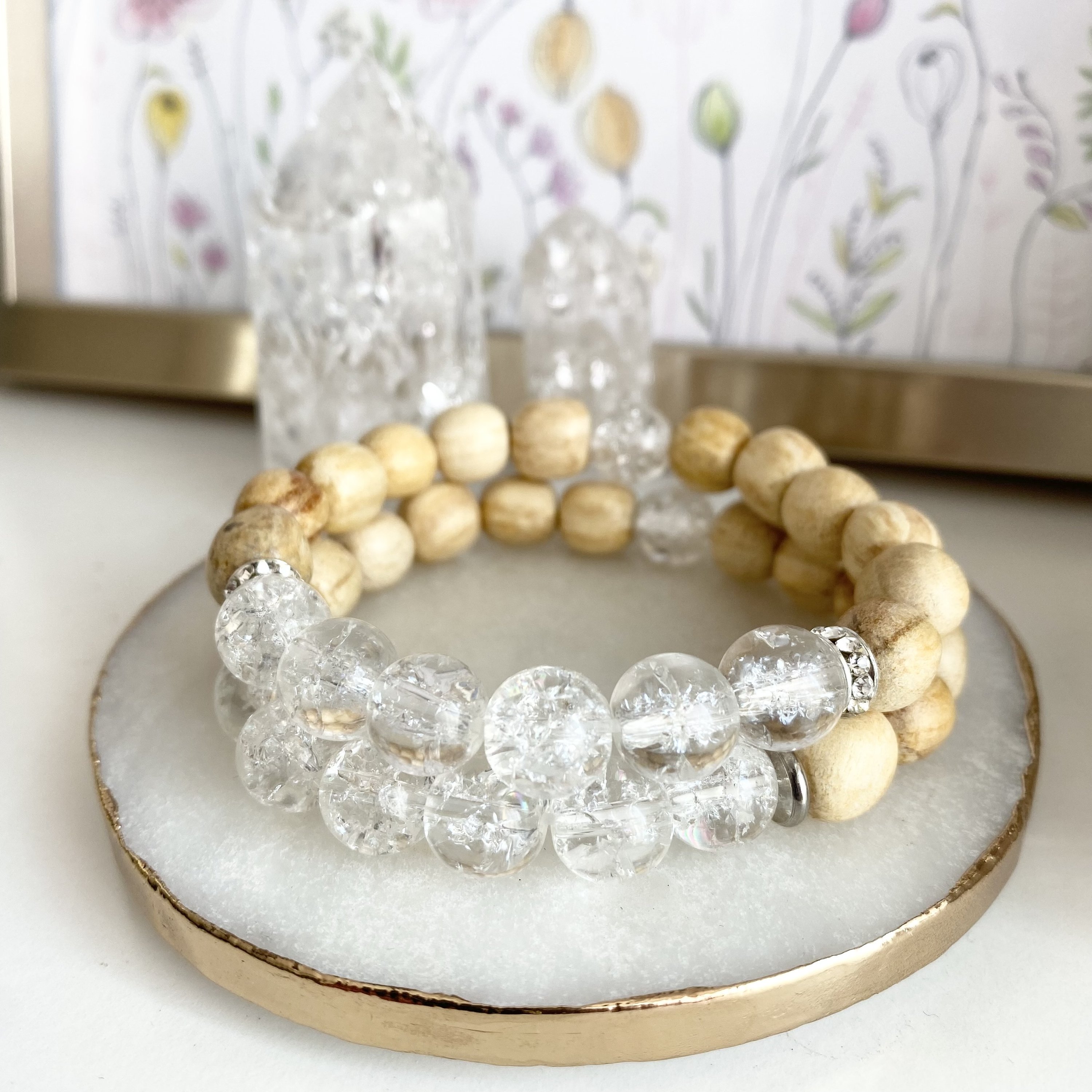 A handmade beaded bracelet featuring 10mm cracked quartz beads and palo santo, designed for meditation and stress relief.