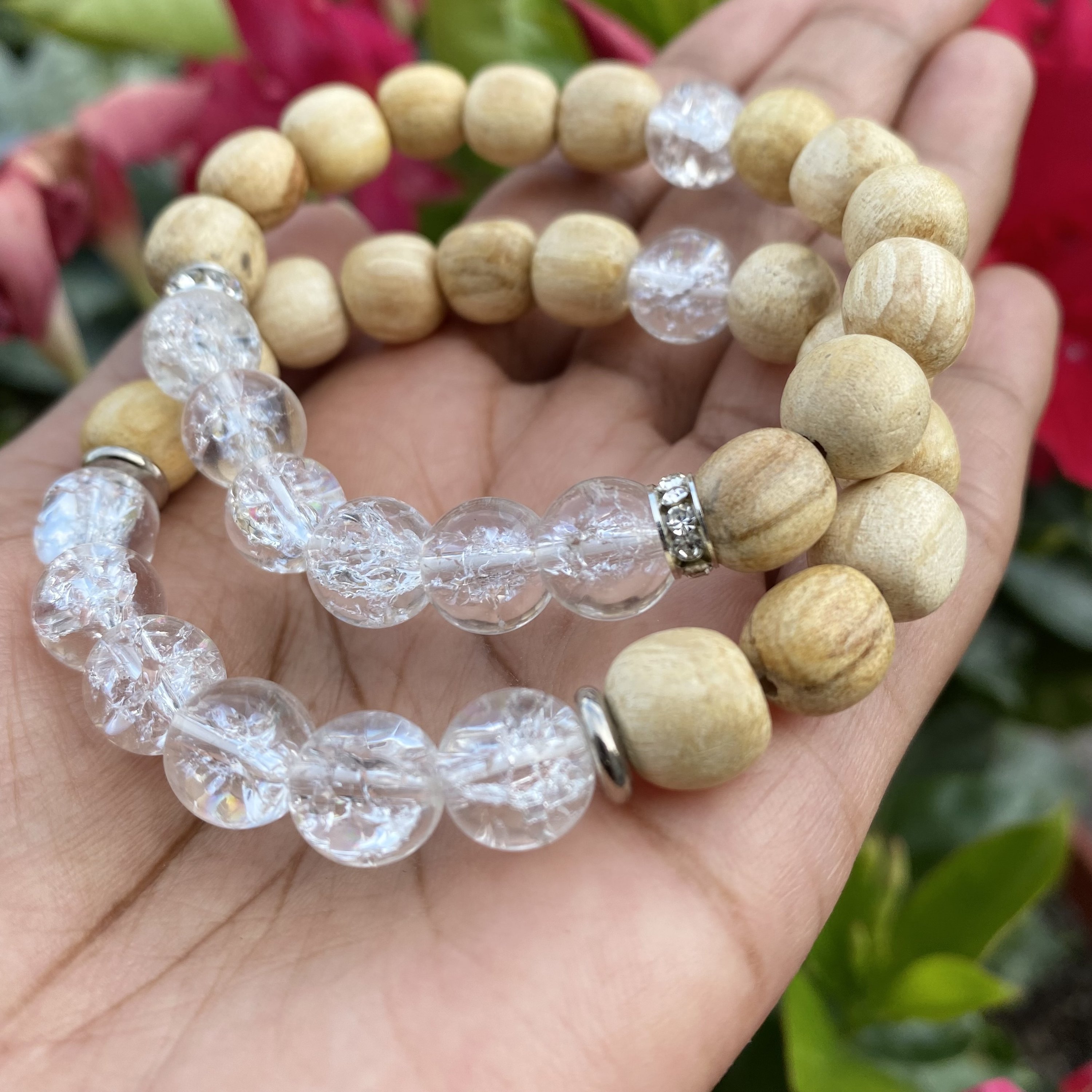 A handmade beaded bracelet featuring 10mm cracked quartz beads and palo santo, designed for meditation and stress relief.