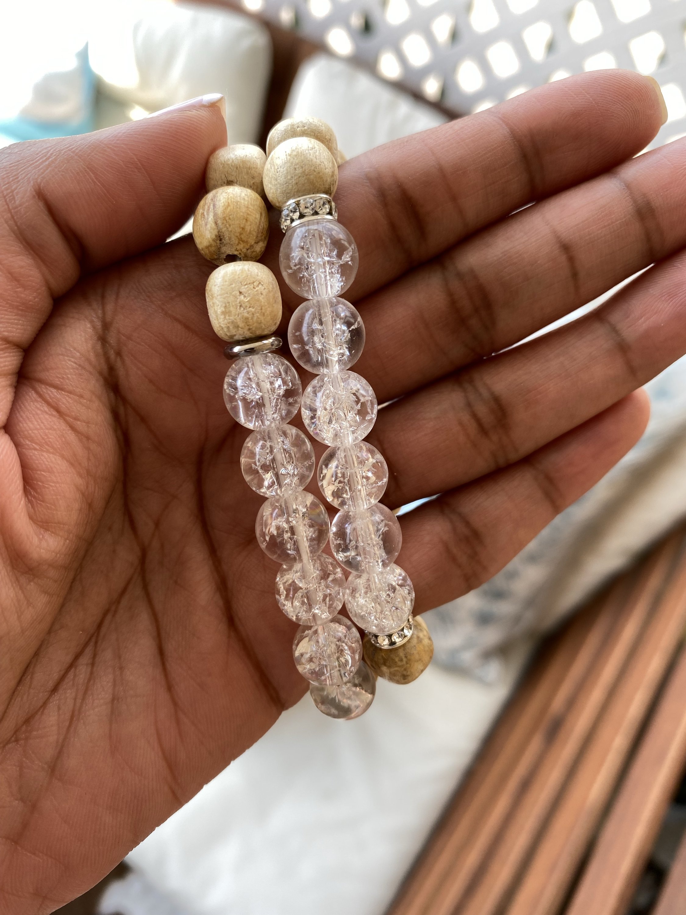 A handmade beaded bracelet featuring 10mm cracked quartz beads and palo santo, designed for meditation and stress relief.