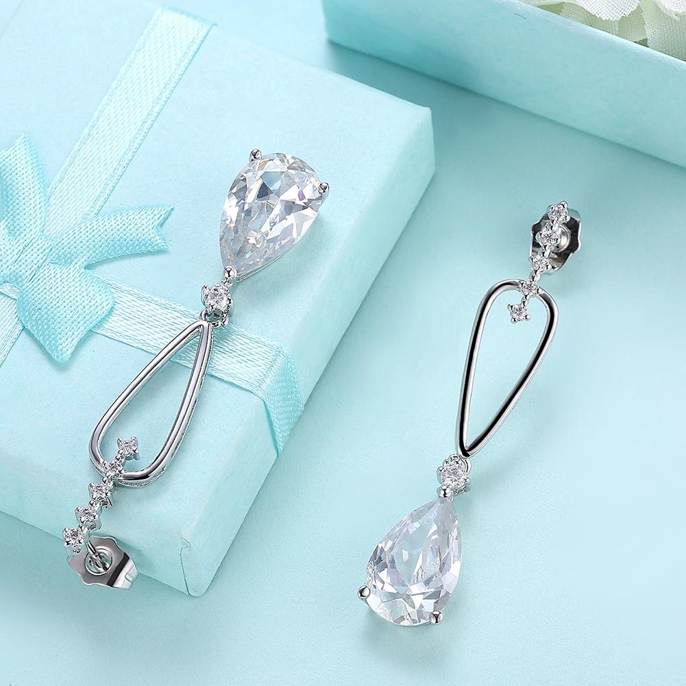 Elegant pear-shaped crystal dangling earrings set in 18K white gold, showcasing their stunning design and craftsmanship.