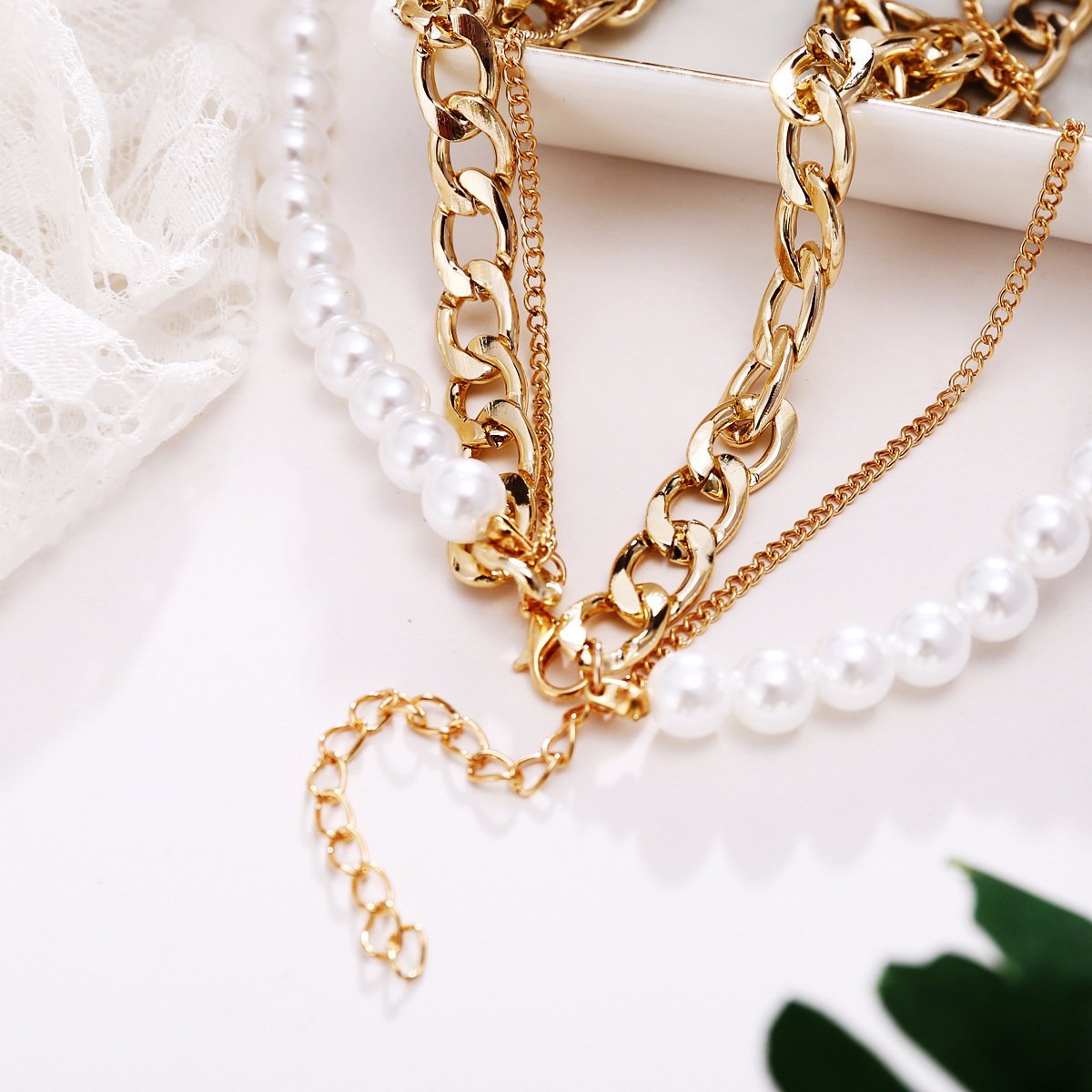 Elegant 18K gold plated necklace featuring pearl and curb link design, adjustable length with lobster clasp closure.