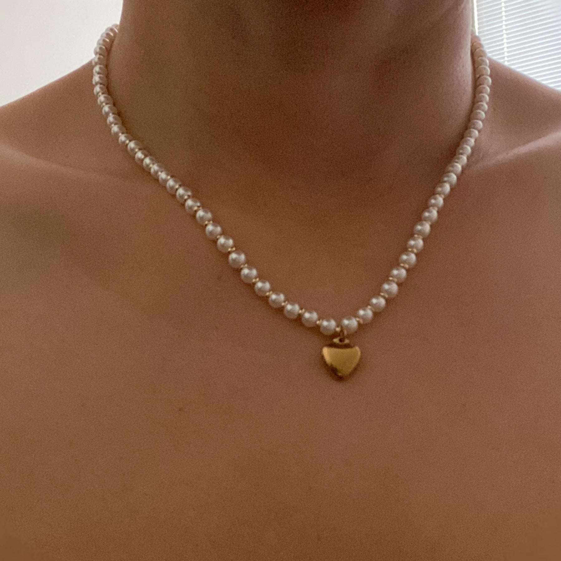 A stylish Pearl and Gold Bauble Heart Necklace featuring alternating pearl and gold beads with a golden heart charm.