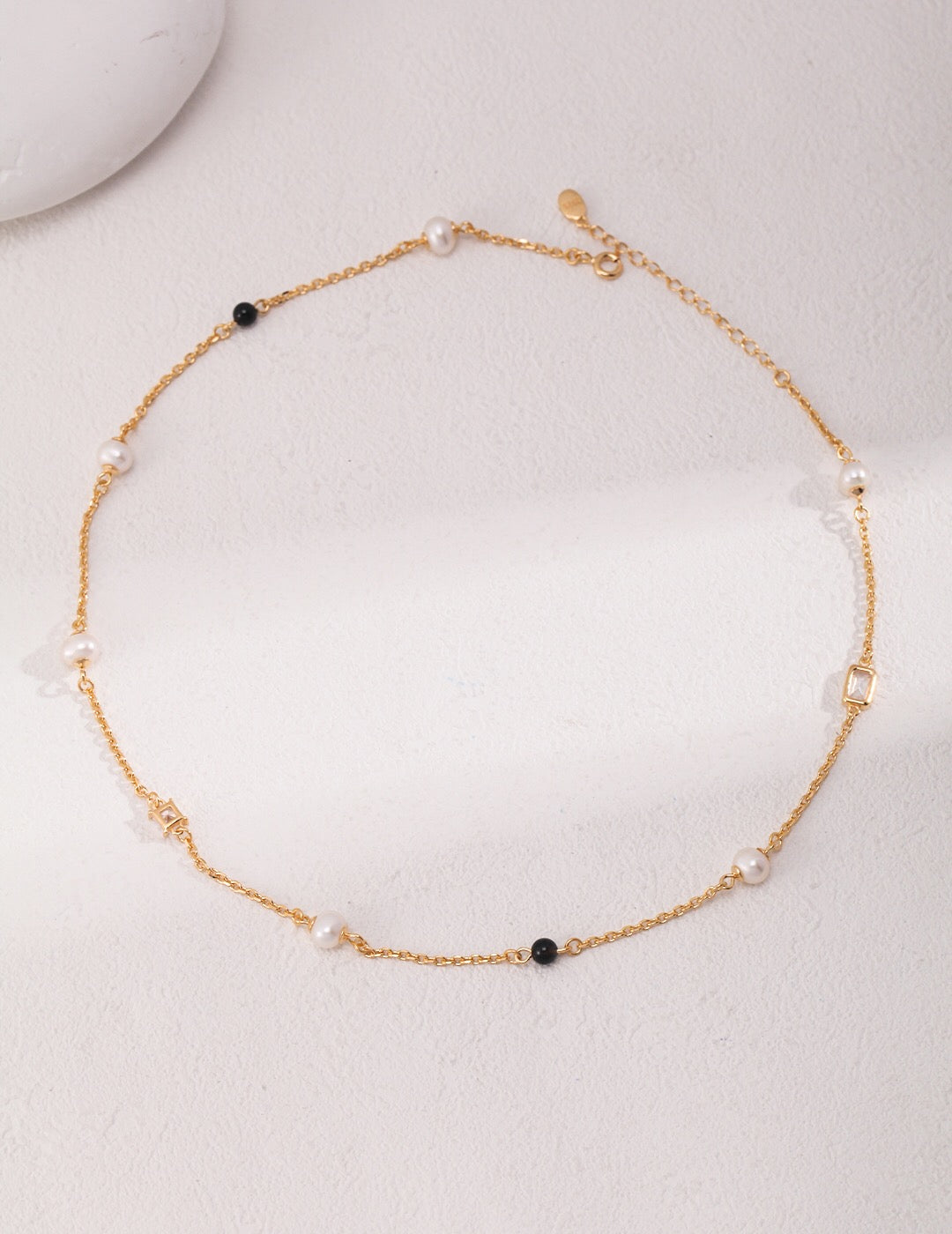 Elegant Pearl Black Onyx Cubic Zirconia Chain Necklace featuring black agate, freshwater pearls, and gold vermeil, showcasing its luxurious design.