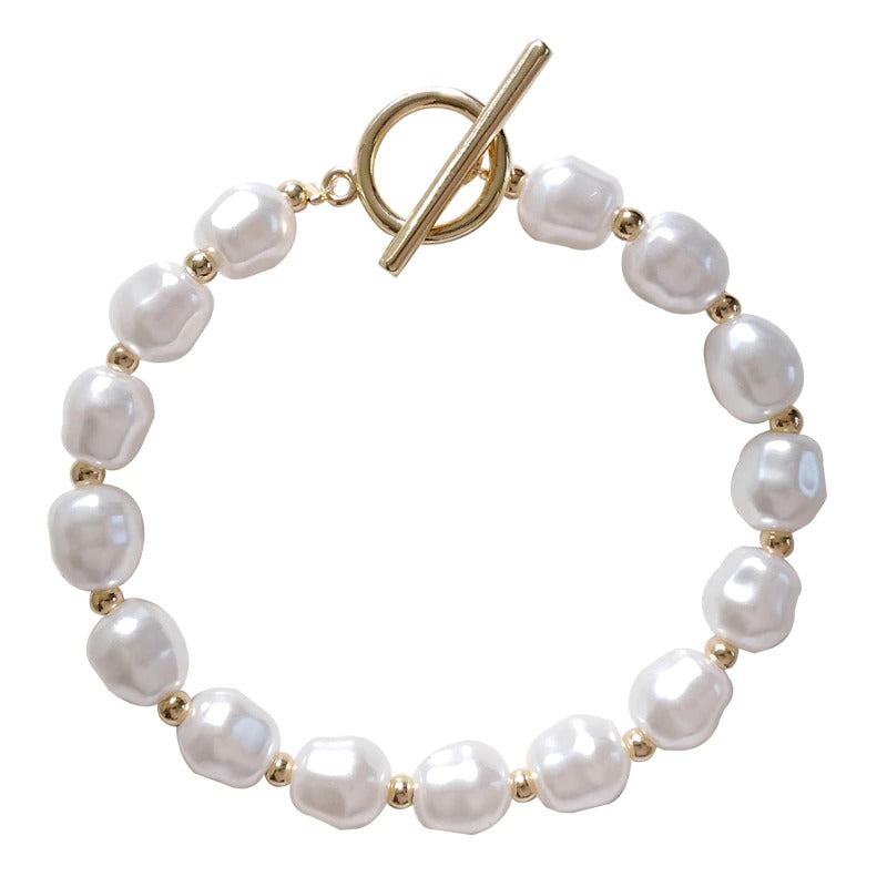 Elegant faux pearl bracelet with 18k gold plating, featuring 15 faux pearls and a toggle clasp, perfect for any occasion.