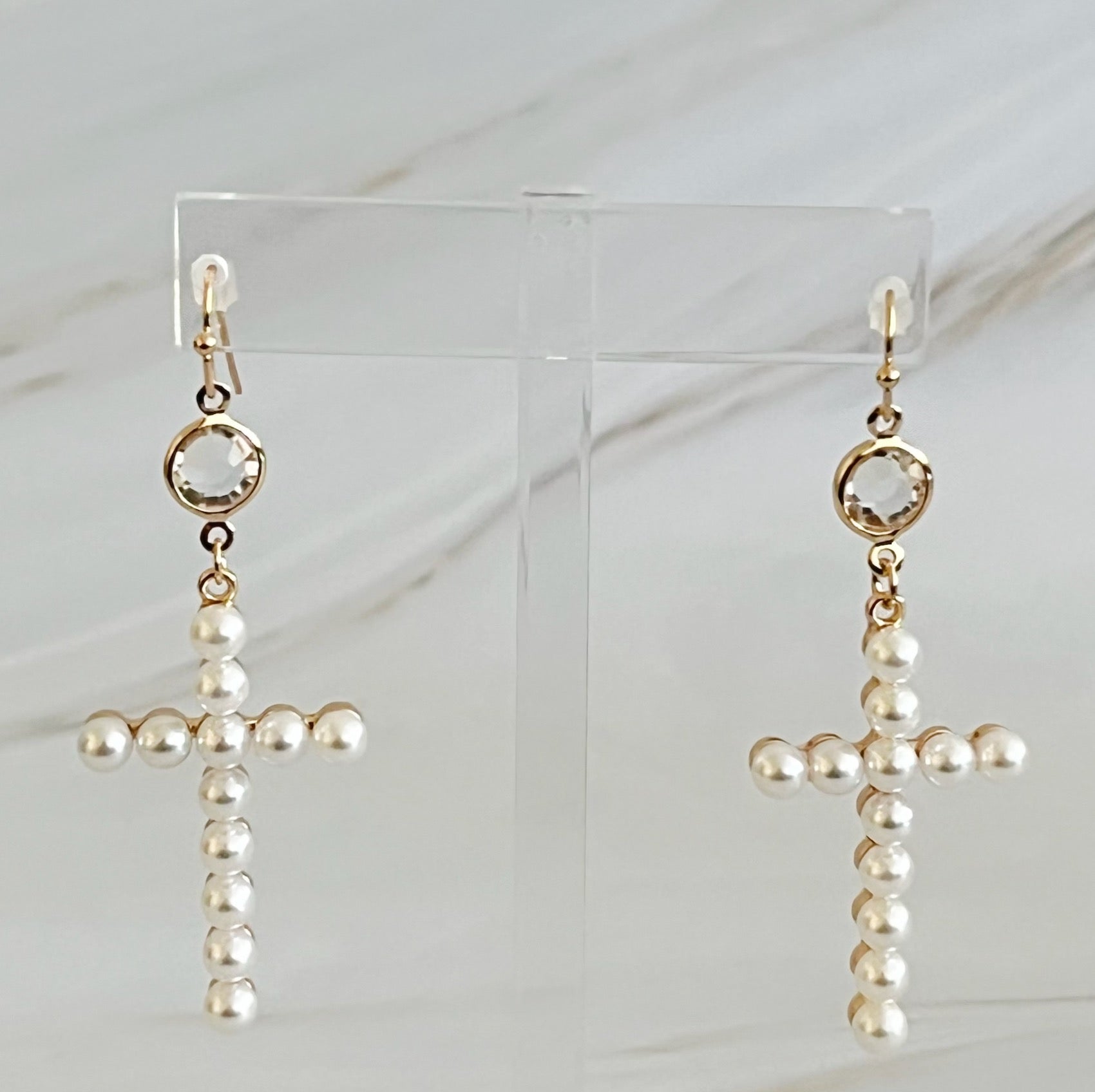 Elegant Pearl Cross Dangle Earrings featuring pearl accents and a unique cross design, perfect for any occasion.