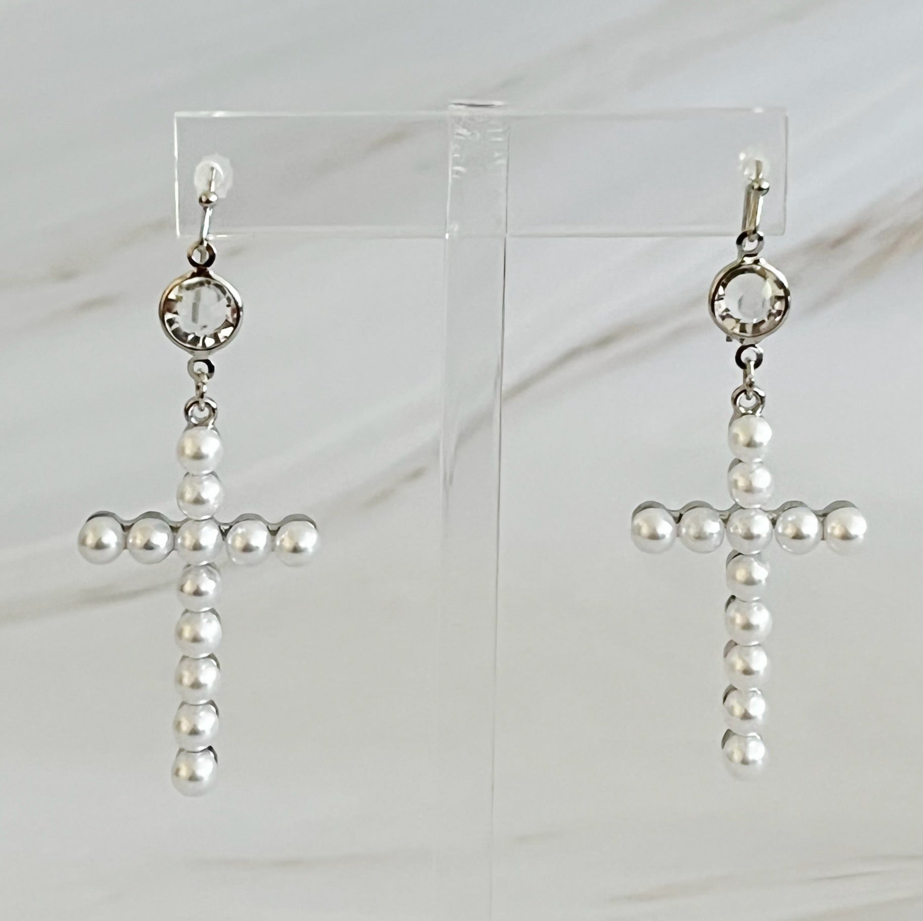 Elegant Pearl Cross Dangle Earrings featuring pearl accents and a unique cross design, perfect for any occasion.