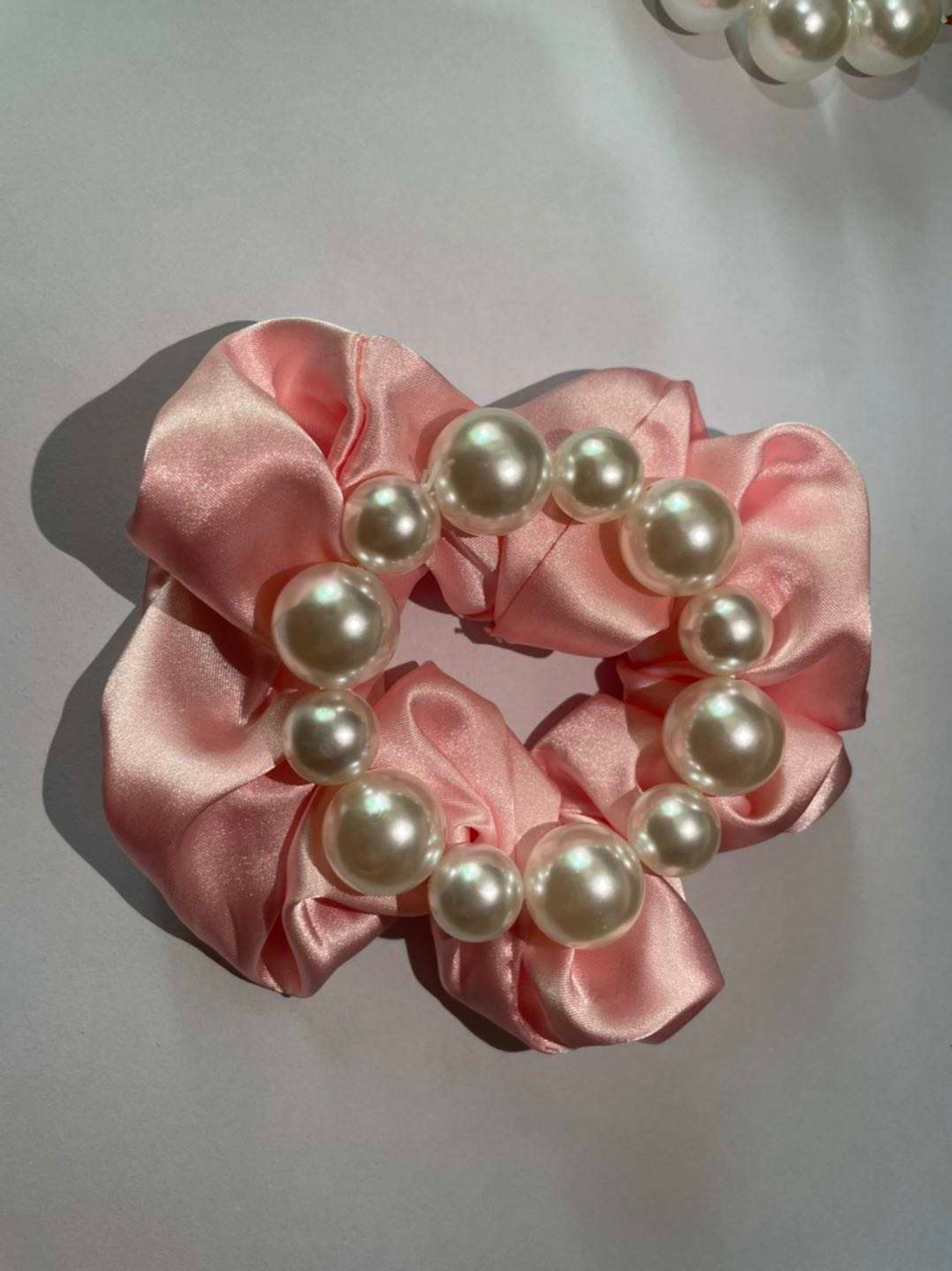 A stylish Pearl & Satin Scrunchie Set featuring elegant satin fabric and pearl accents, perfect for any hairstyle.