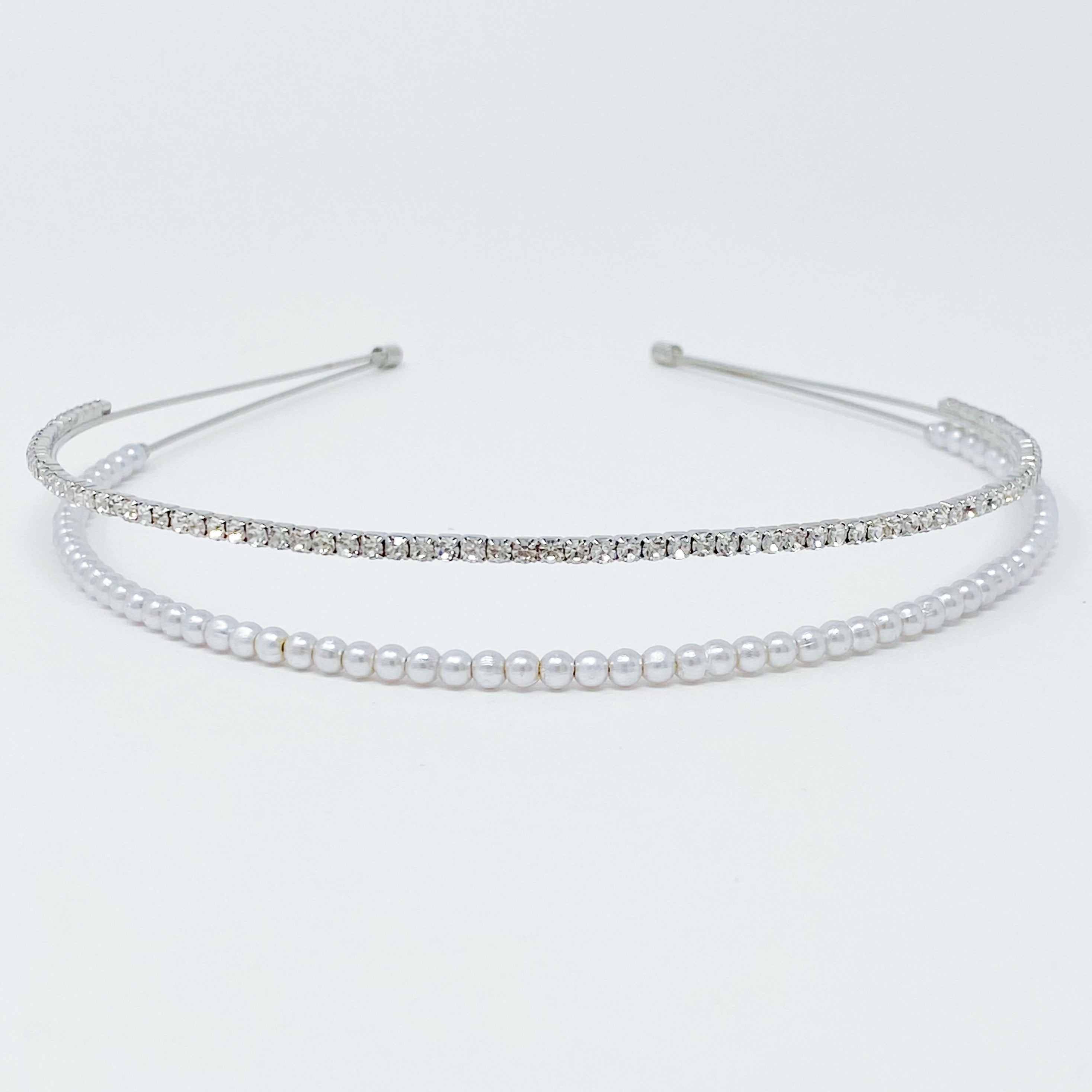 A stylish headband featuring glass pearls and rhinestones, perfect for girls' accessories.