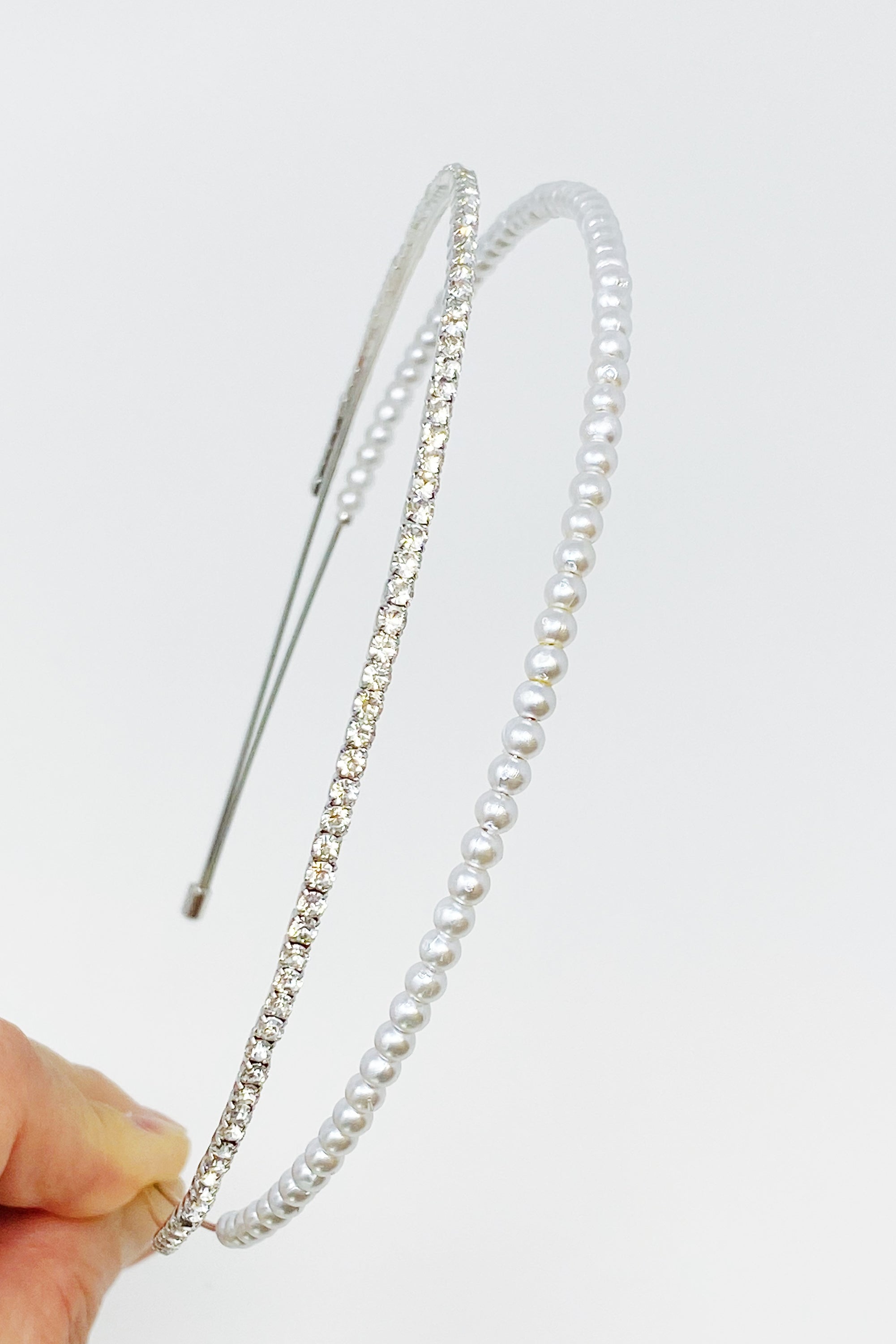 A stylish headband featuring glass pearls and rhinestones, perfect for girls' accessories.