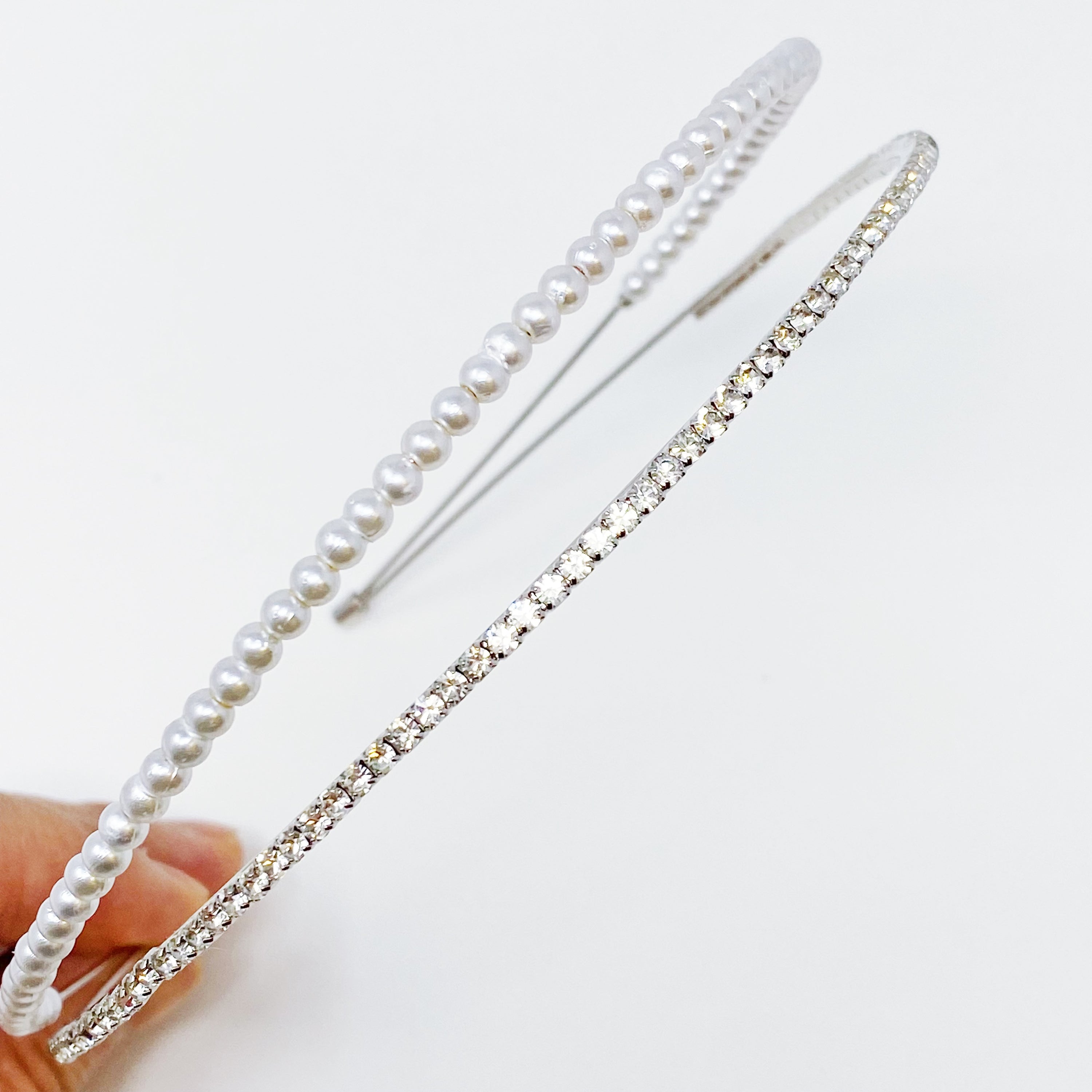 A stylish headband featuring glass pearls and rhinestones, perfect for girls' accessories.