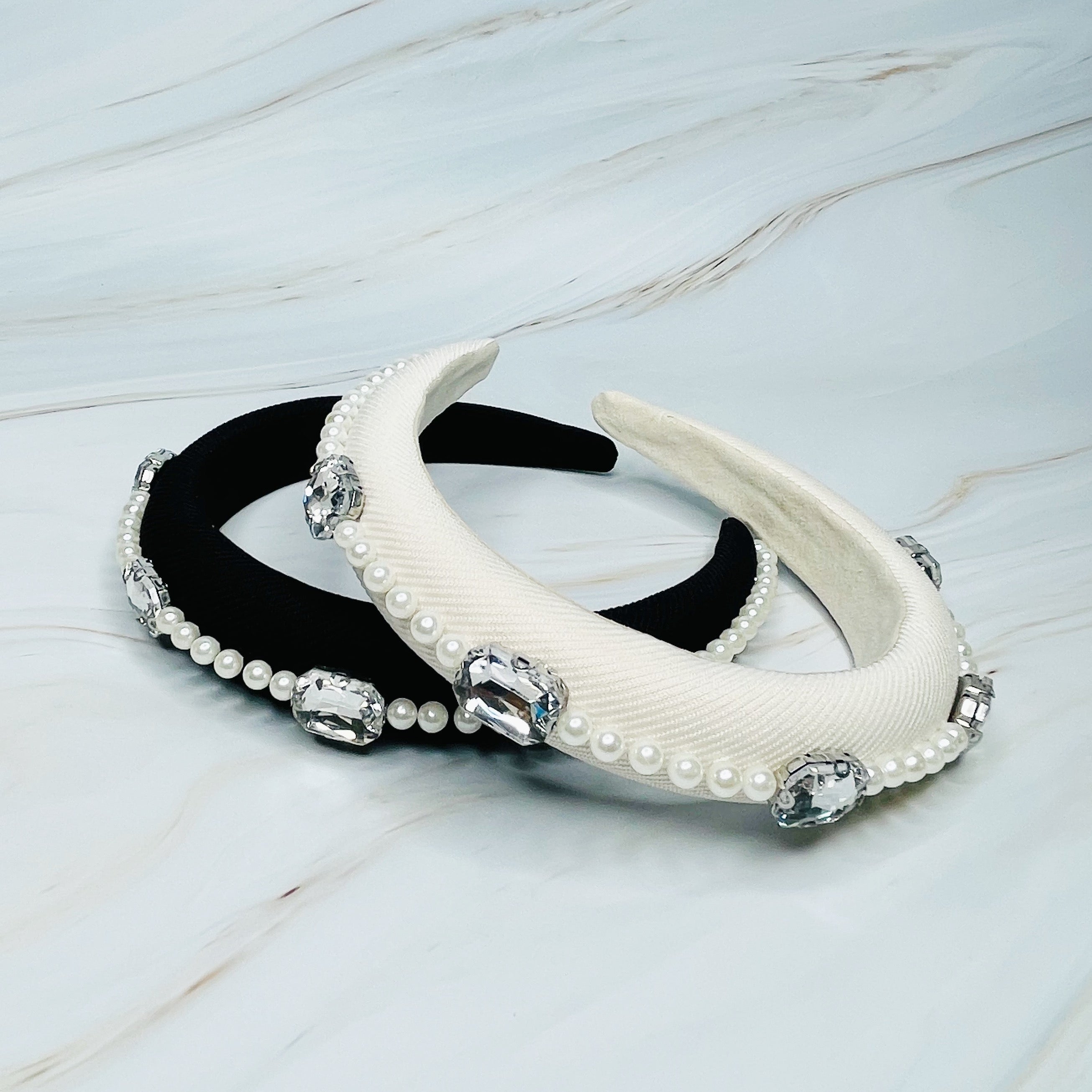 A luxurious Pearls And Jewels Lined Headband featuring elegant pearl and jewel embellishments on a soft material.