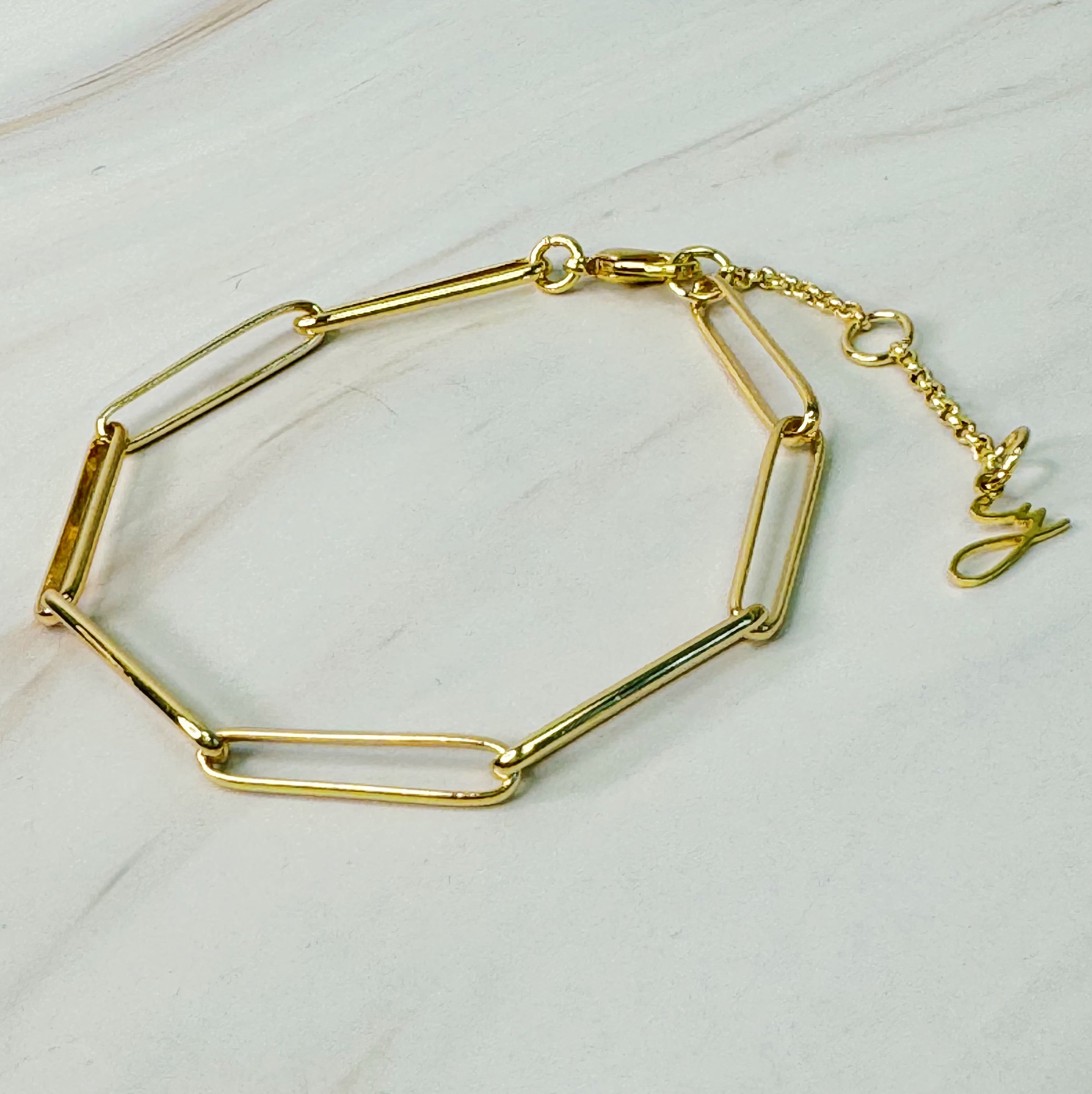 A sleek Perfect Clip Link Chain Bracelet made of 18k gold plated brass, featuring linked clips and a 2-inch extender for adjustable fit.