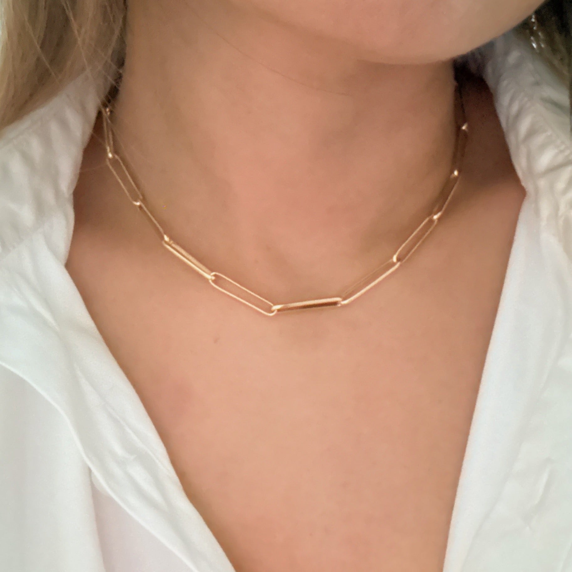 A stylish Perfect Clip Link Chain Necklace featuring sleek gold-plated links, showcasing its modern design and elegant finish.