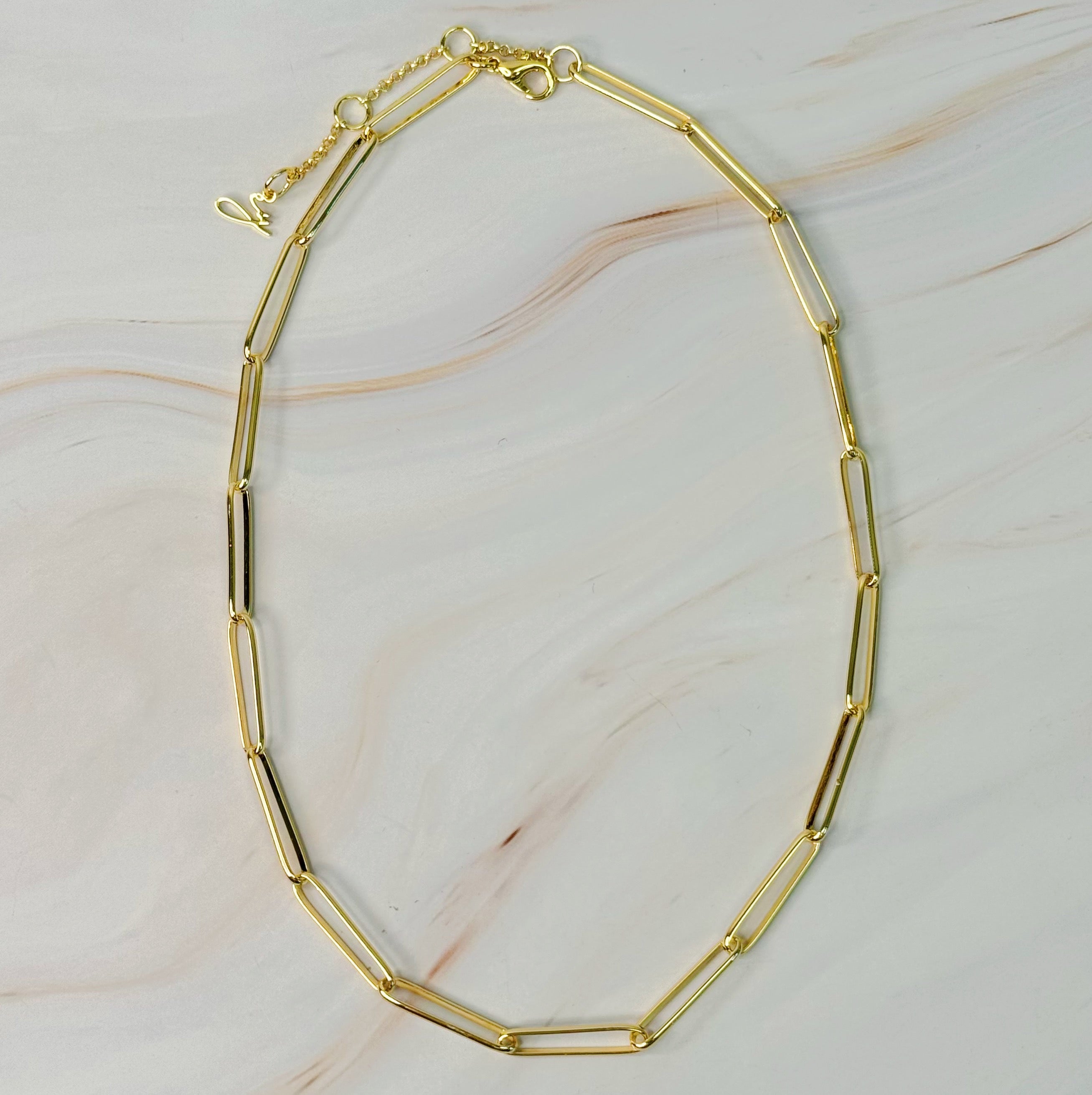 A stylish Perfect Clip Link Chain Necklace featuring sleek gold-plated links, showcasing its modern design and elegant finish.