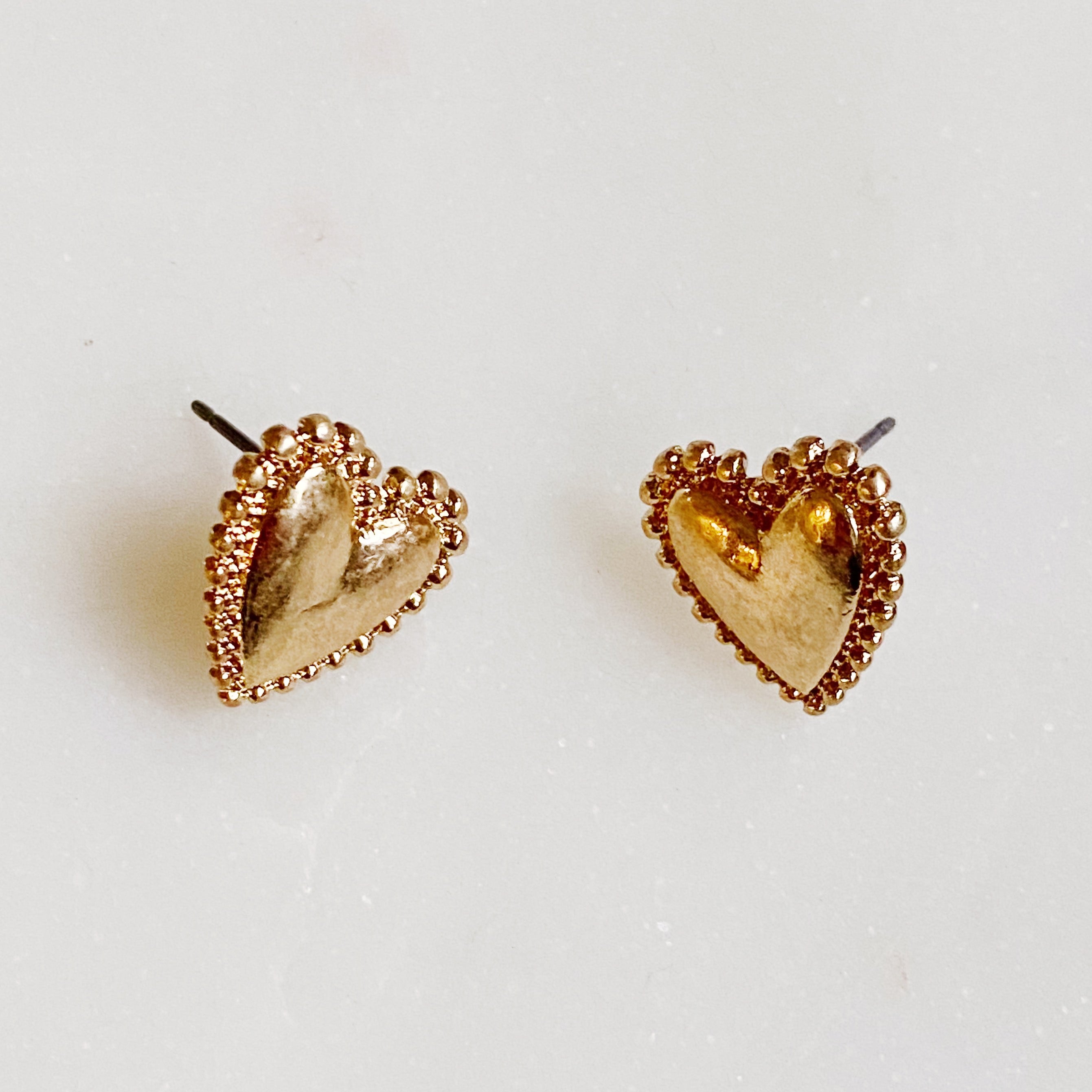 A stylish set of 3 heart earrings in different designs, showcasing versatility and elegance.