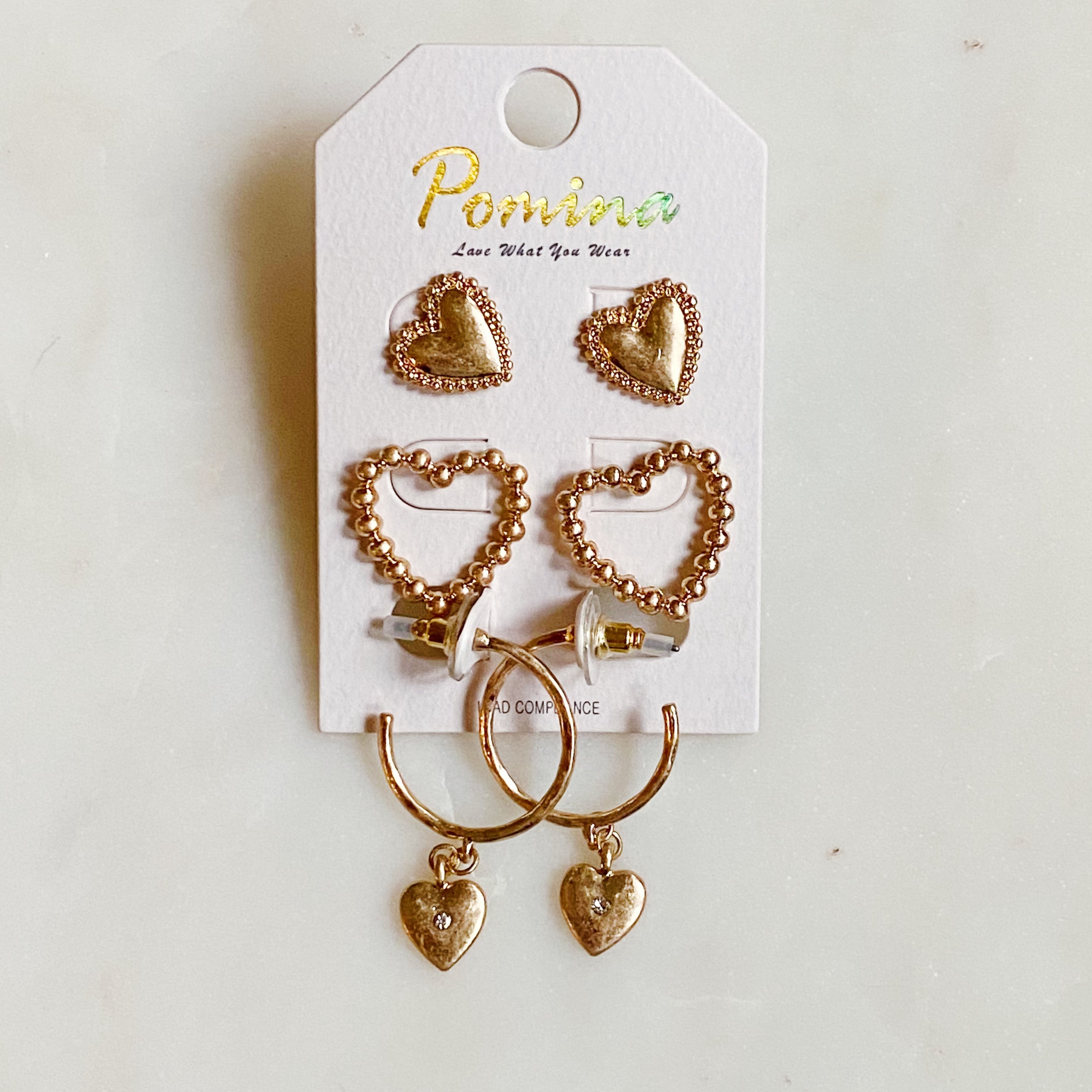 A stylish set of 3 heart earrings in different designs, showcasing versatility and elegance.