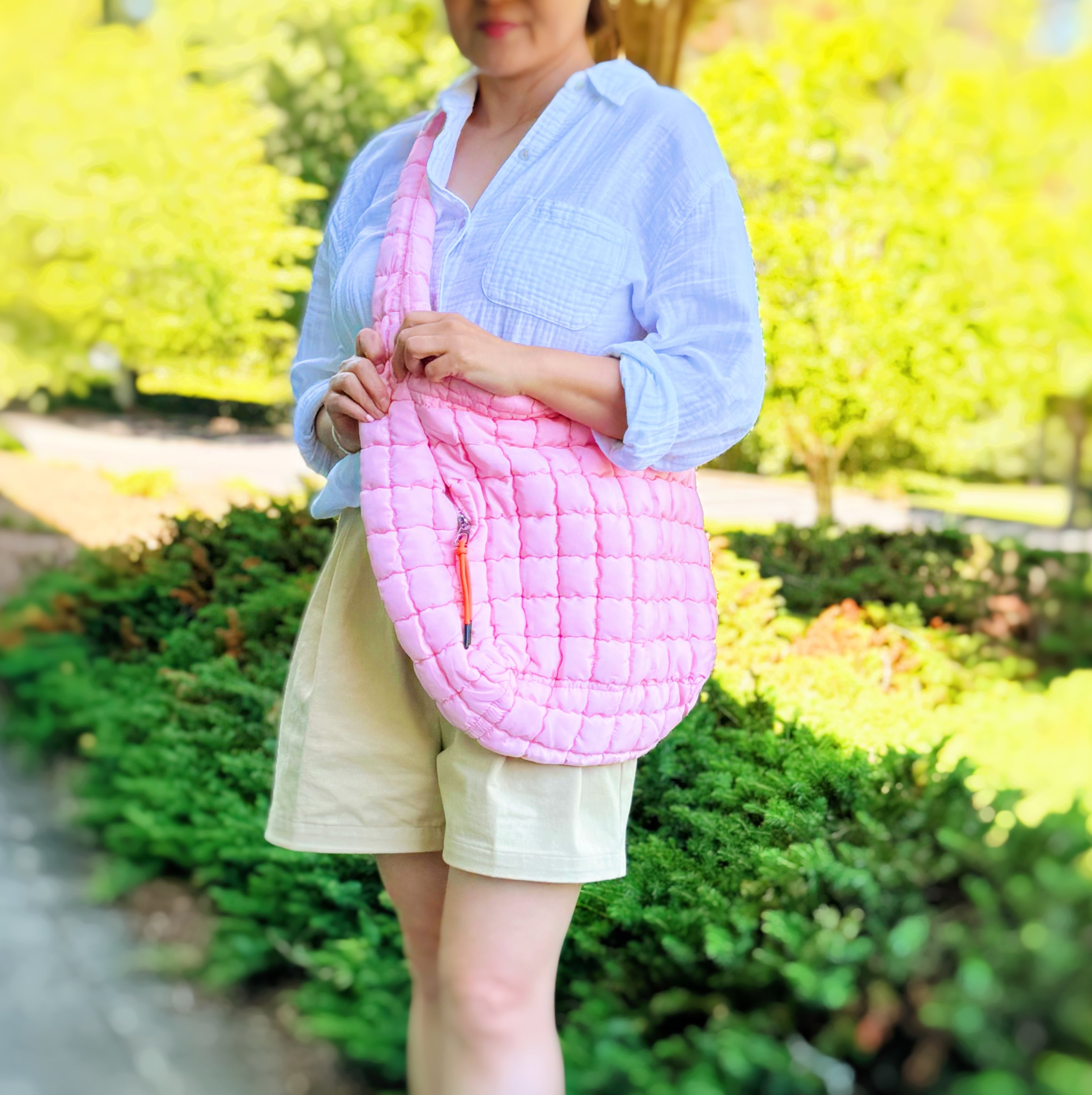 A stylish Perfect Puffy Large Quilted Bag in vibrant colors, featuring a quilted design, zipper pulls, and multiple pockets.