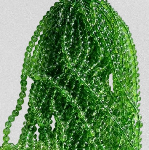 A strand of 46 natural Peridot semi-precious stone beads, each 8 mm in size, showcasing their vibrant green color and natural beauty.