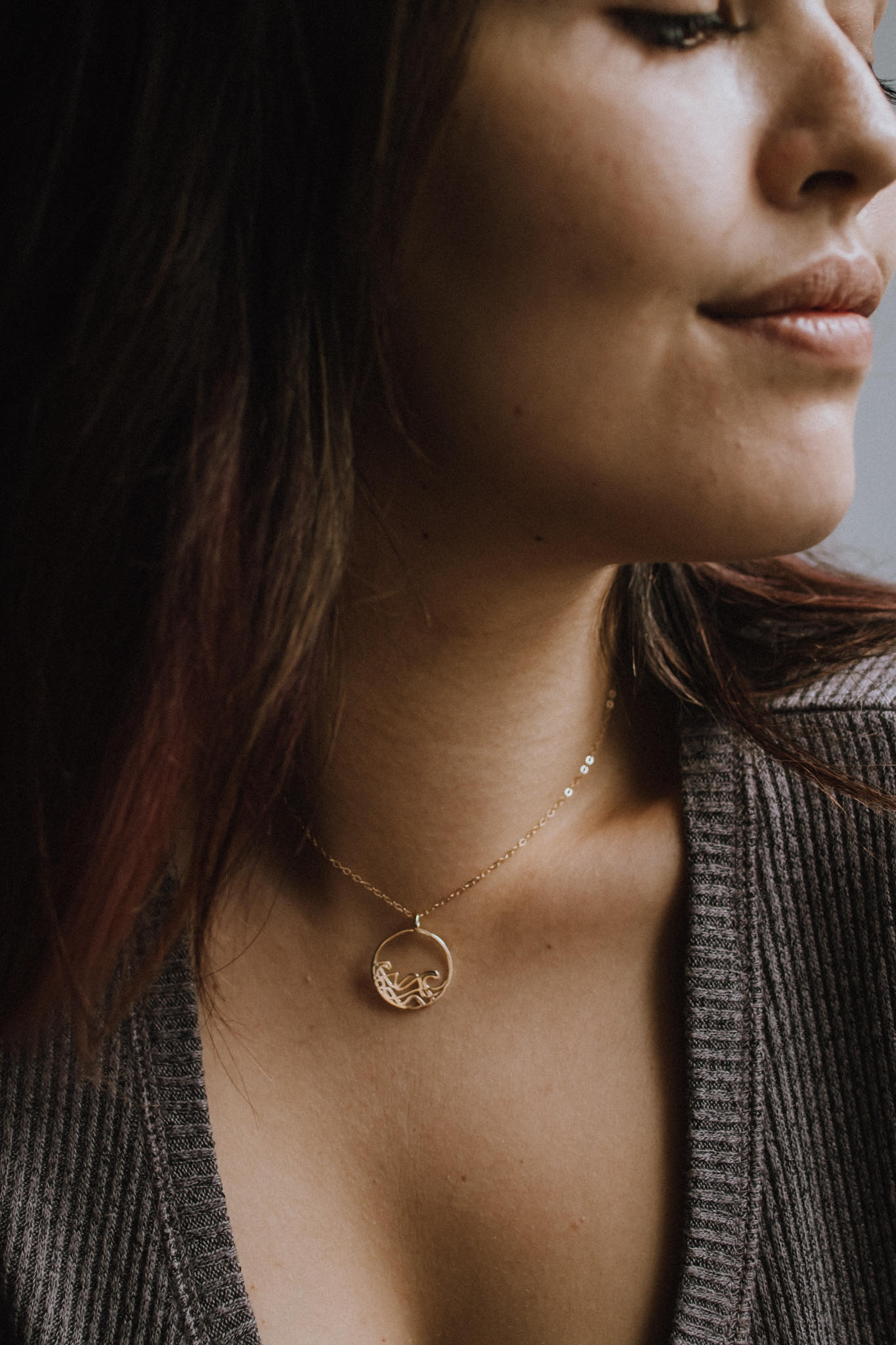 A delicate 20mm Petite Sombrio Surf Wave Circle Necklace in 925 sterling silver with rhodium, rose gold, and yellow gold plating options.