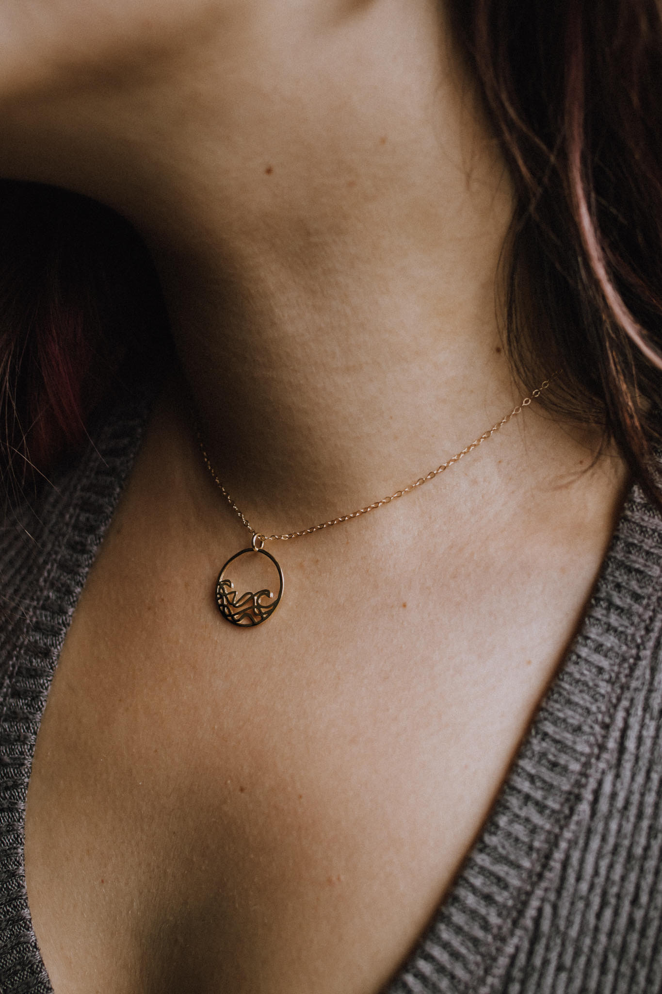 A delicate 20mm Petite Sombrio Surf Wave Circle Necklace in 925 sterling silver with rhodium, rose gold, and yellow gold plating options.