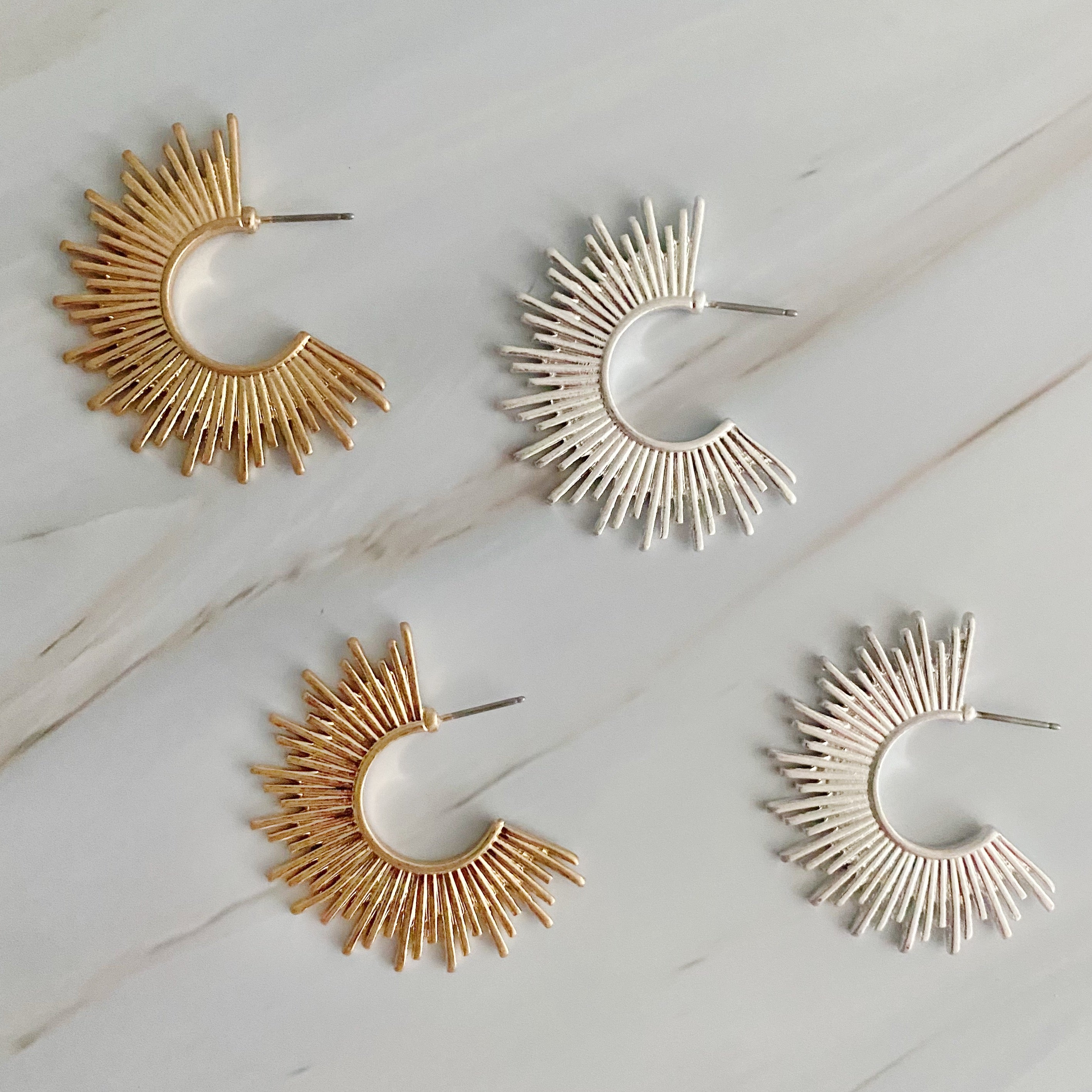 Pharaoh Half Hoop Earrings featuring a spiky design, crafted from plated metal, showcasing an edgy and sophisticated look.