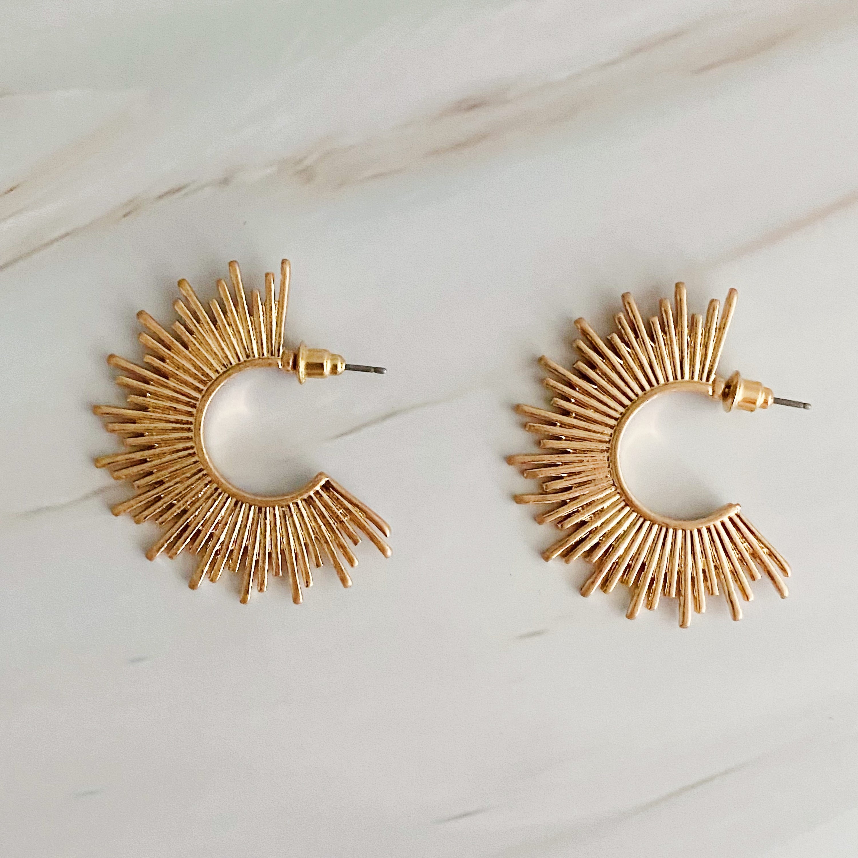 Pharaoh Half Hoop Earrings featuring a spiky design, crafted from plated metal, showcasing an edgy and sophisticated look.