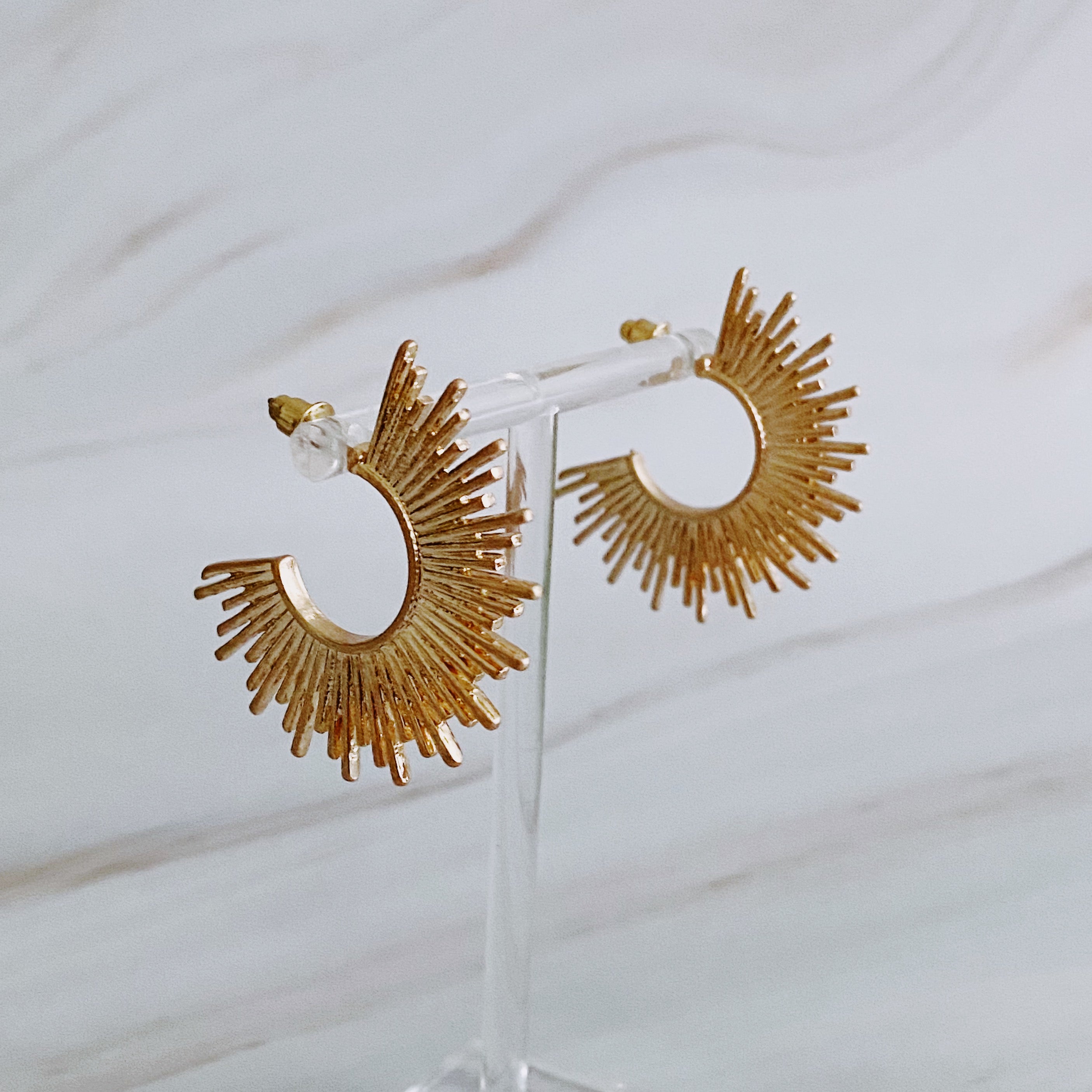 Pharaoh Half Hoop Earrings featuring a spiky design, crafted from plated metal, showcasing an edgy and sophisticated look.