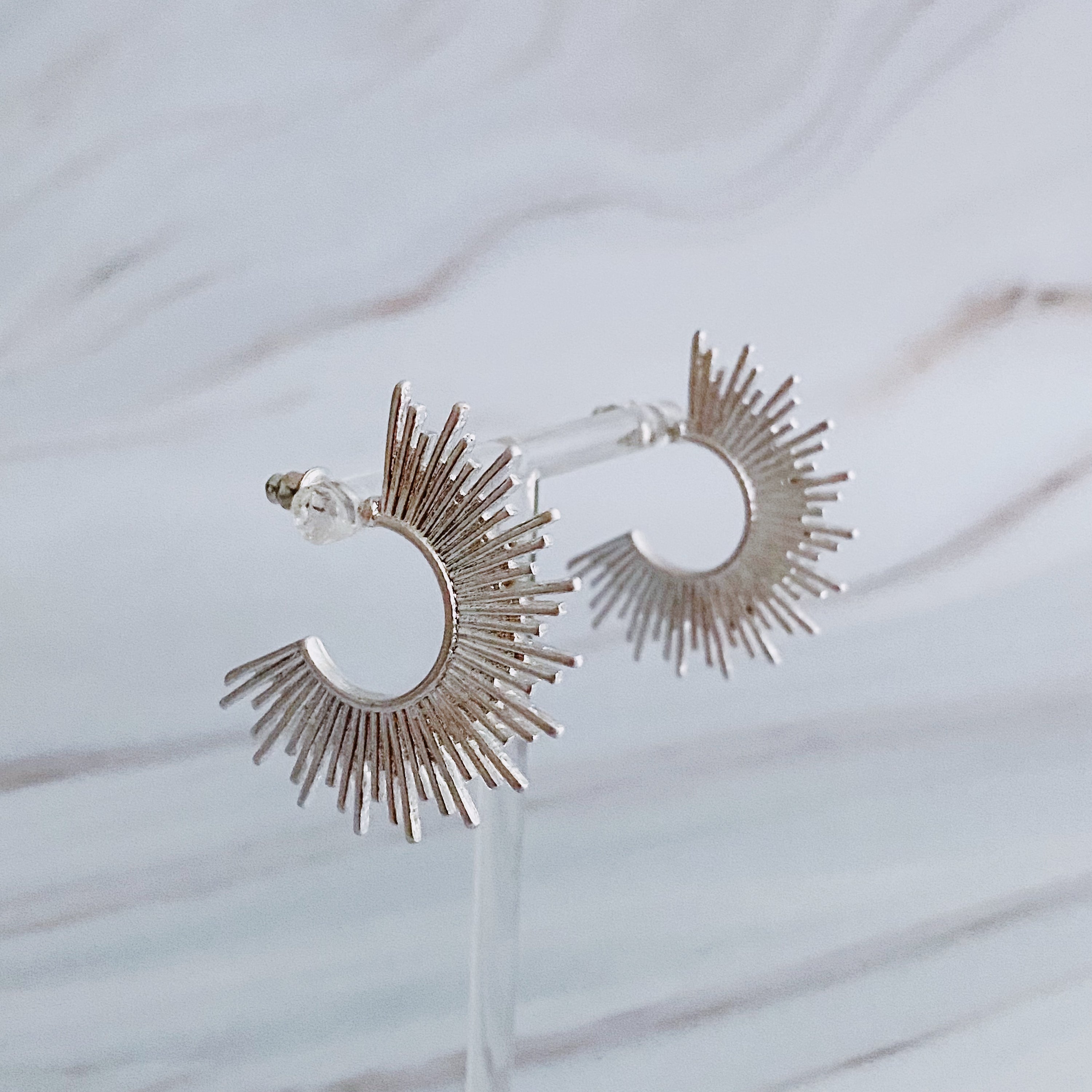 Pharaoh Half Hoop Earrings featuring a spiky design, crafted from plated metal, showcasing an edgy and sophisticated look.