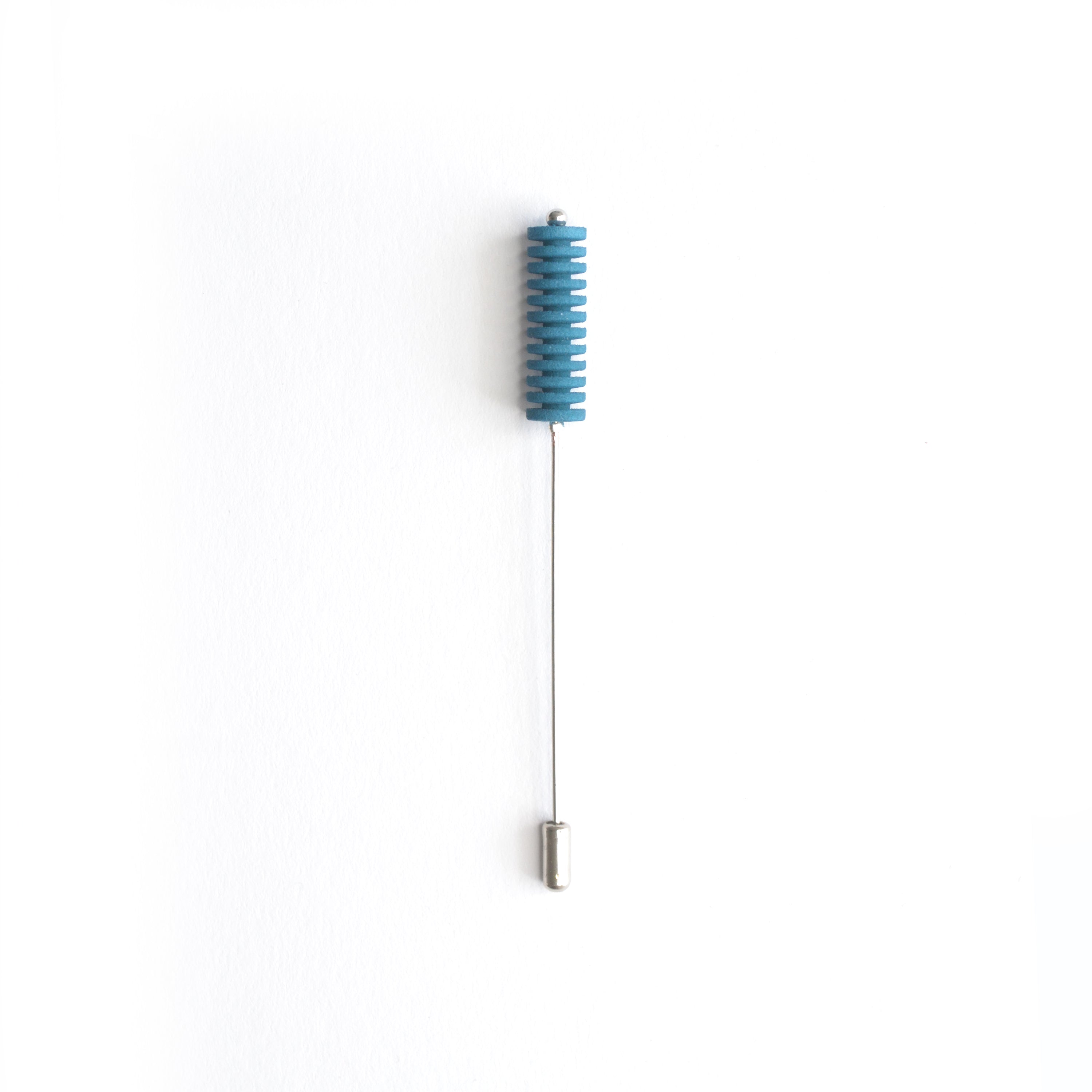 Optical Pin Brooch in various bold colors, showcasing its minimalistic design and versatility as a fashion accessory.