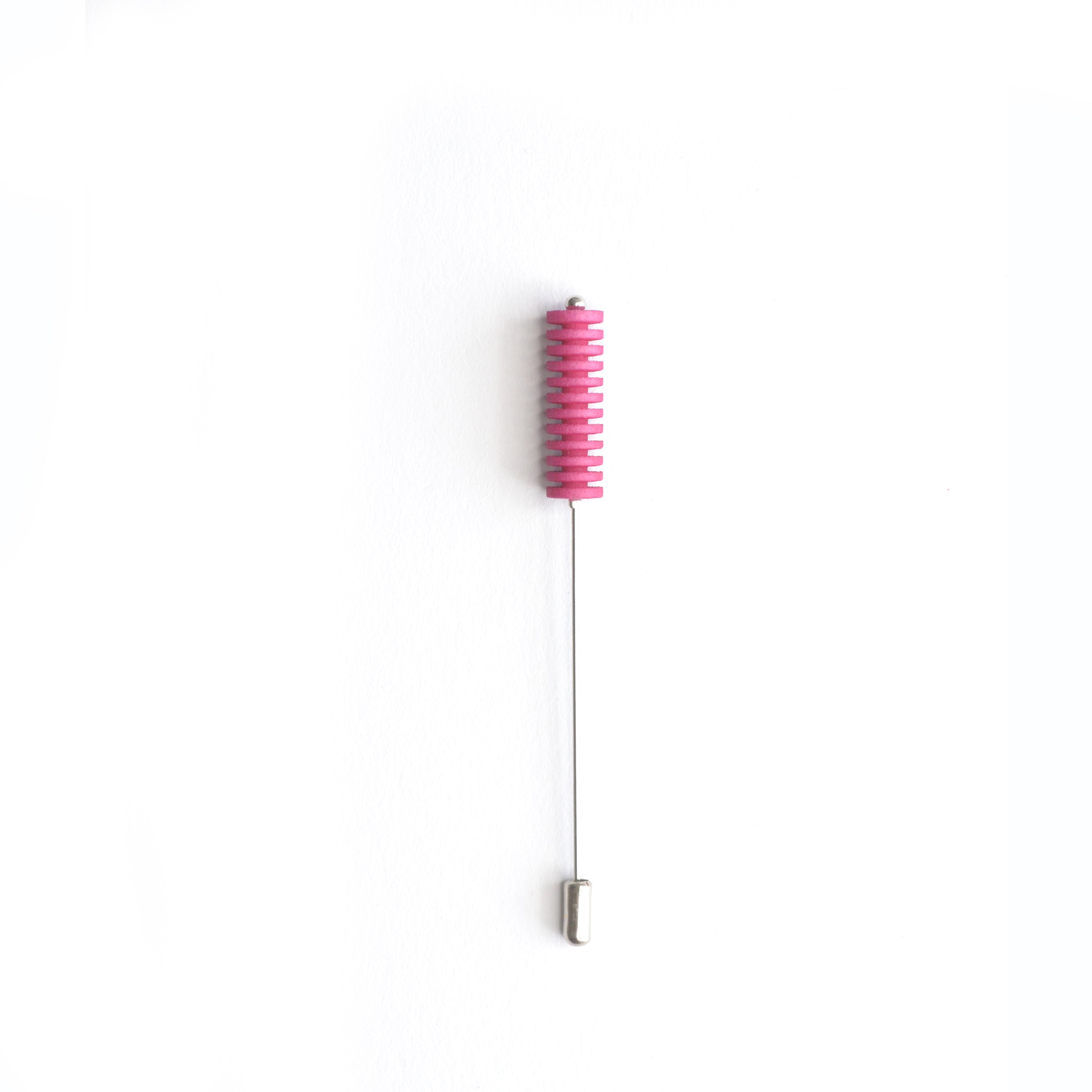 Optical Pin Brooch in various bold colors, showcasing its minimalistic design and versatility as a fashion accessory.