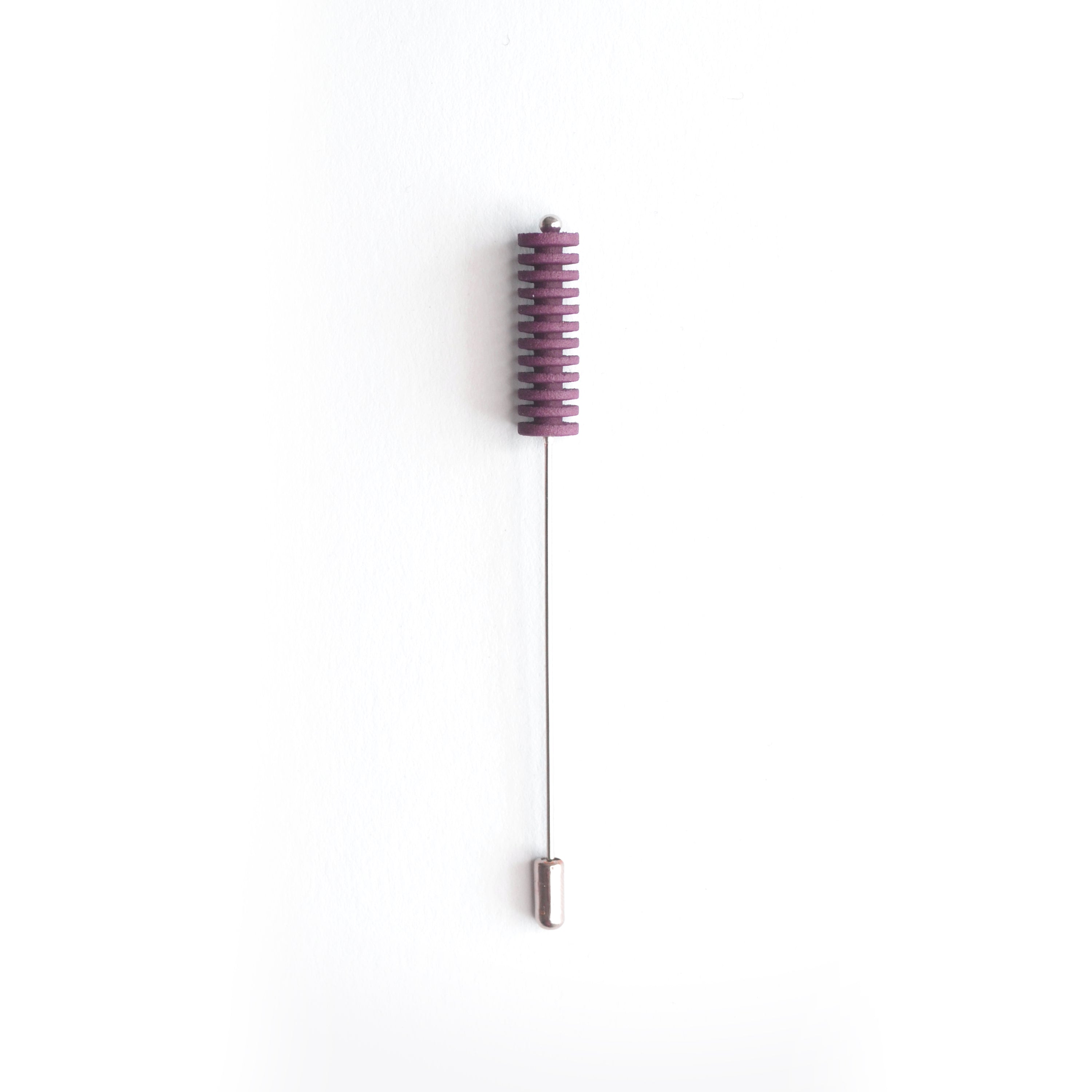 Optical Pin Brooch in various bold colors, showcasing its minimalistic design and versatility as a fashion accessory.