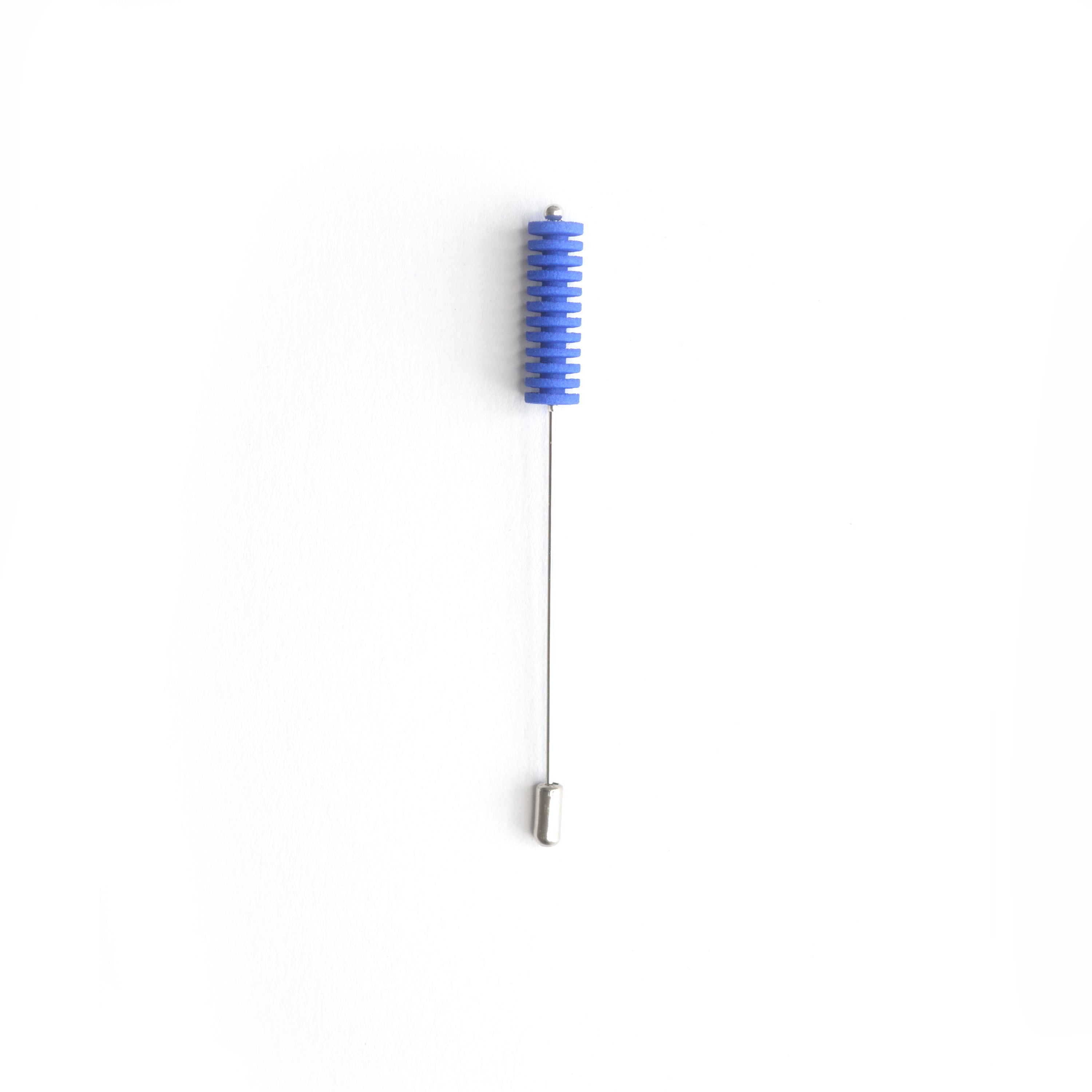 Optical Pin Brooch in various bold colors, showcasing its minimalistic design and versatility as a fashion accessory.