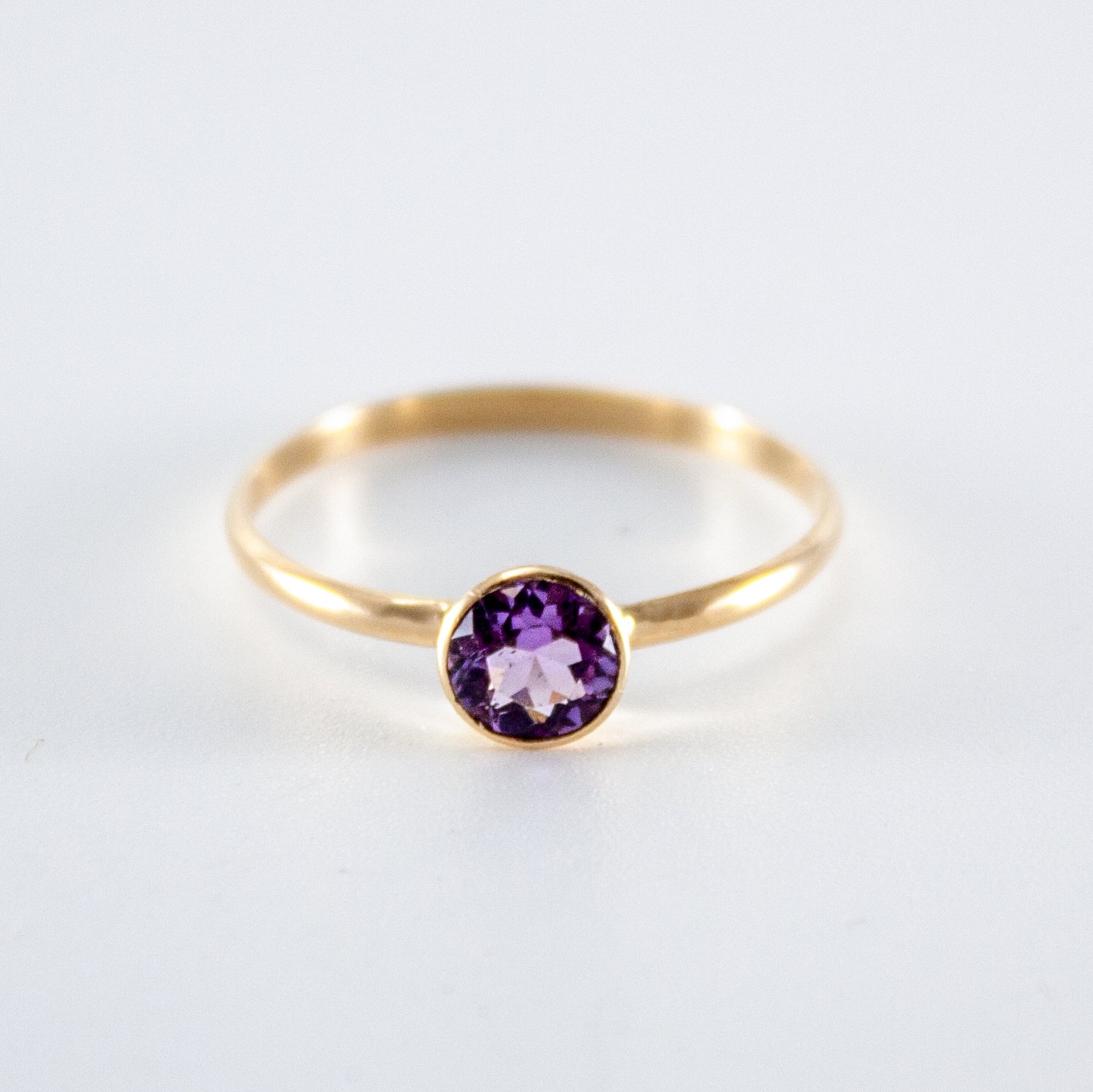 A beautiful Pink Amethyst Bezel 14k Gold Filled Ring showcasing a round brilliant cut Brazilian amethyst in a tapered bezel setting.