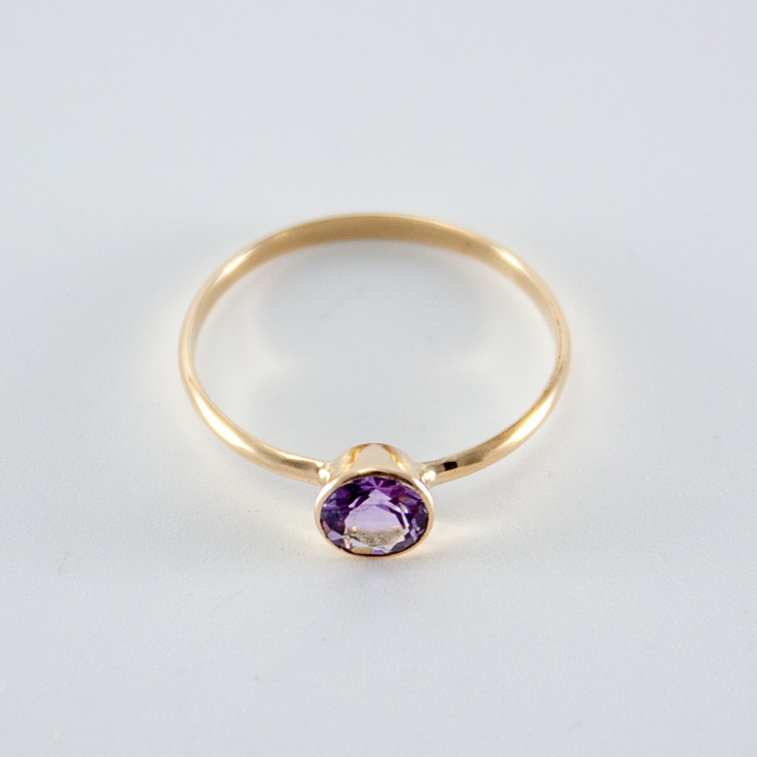 A beautiful Pink Amethyst Bezel 14k Gold Filled Ring showcasing a round brilliant cut Brazilian amethyst in a tapered bezel setting.