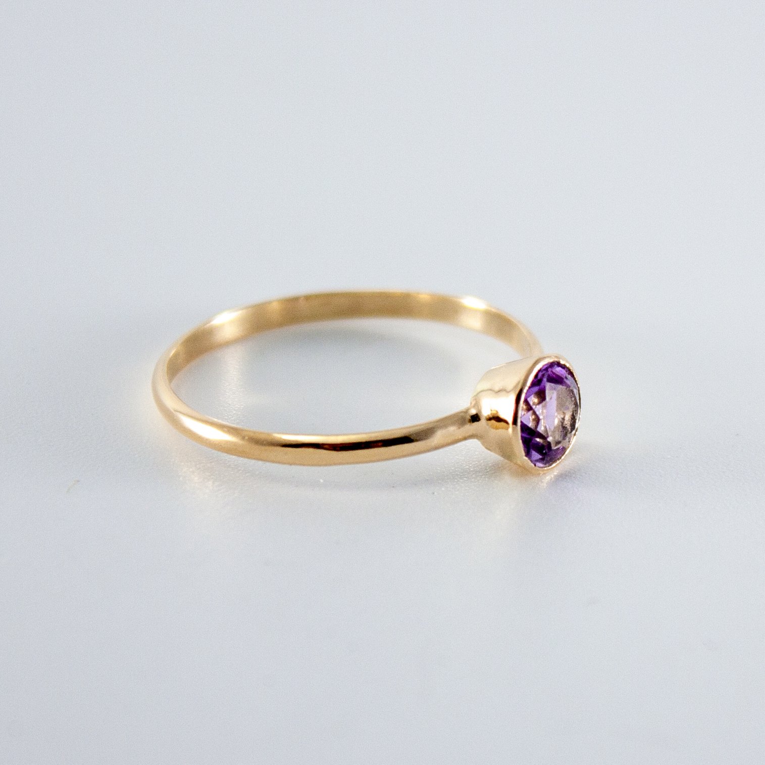 A beautiful Pink Amethyst Bezel 14k Gold Filled Ring showcasing a round brilliant cut Brazilian amethyst in a tapered bezel setting.