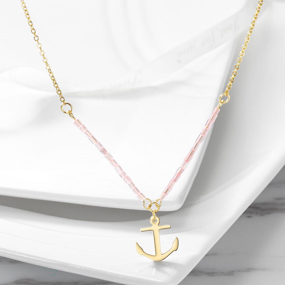 A beautiful pink beaded anchor pendant necklace made from stainless steel with gold plating, showcasing elegance and durability.