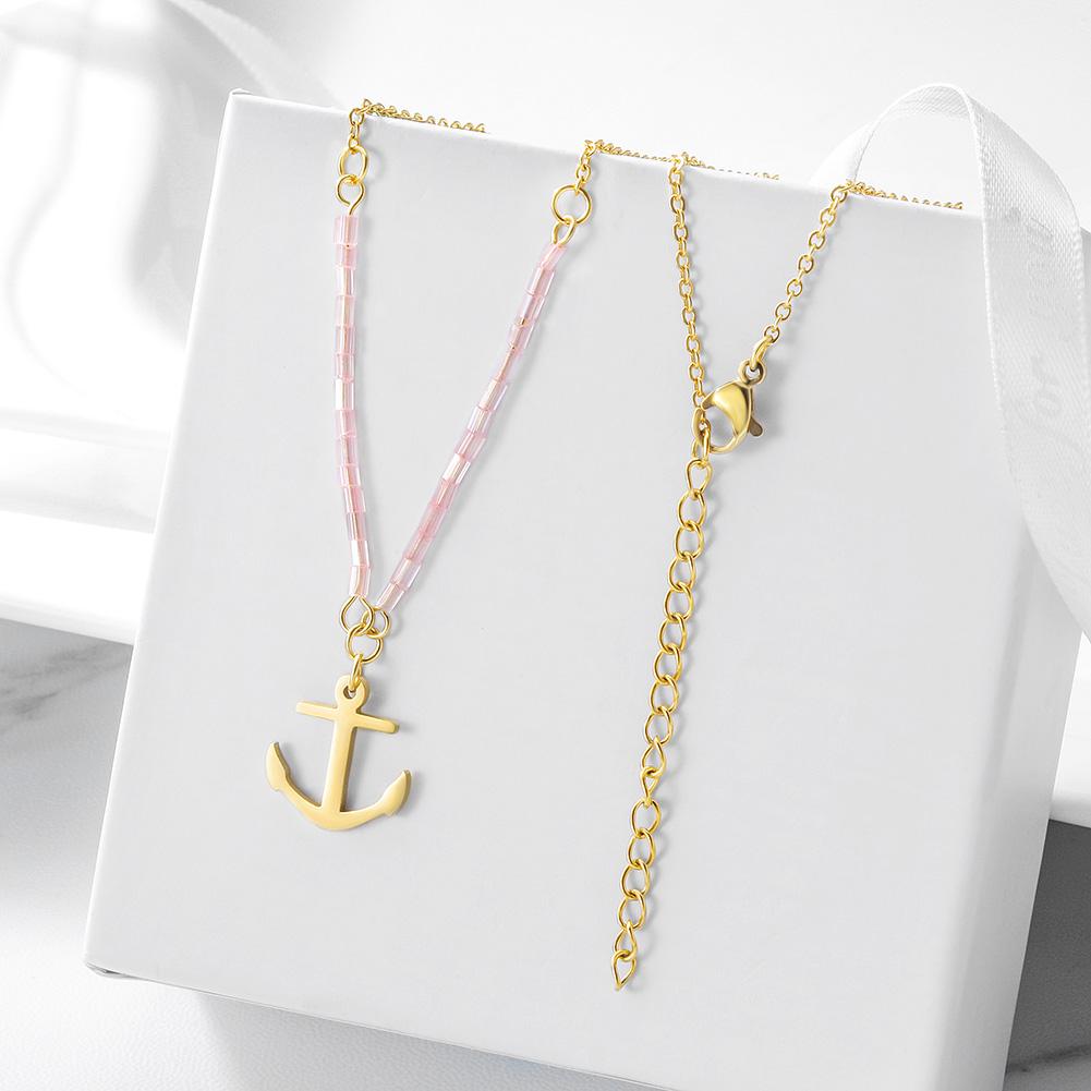 A beautiful pink beaded anchor pendant necklace made from stainless steel with gold plating, showcasing elegance and durability.