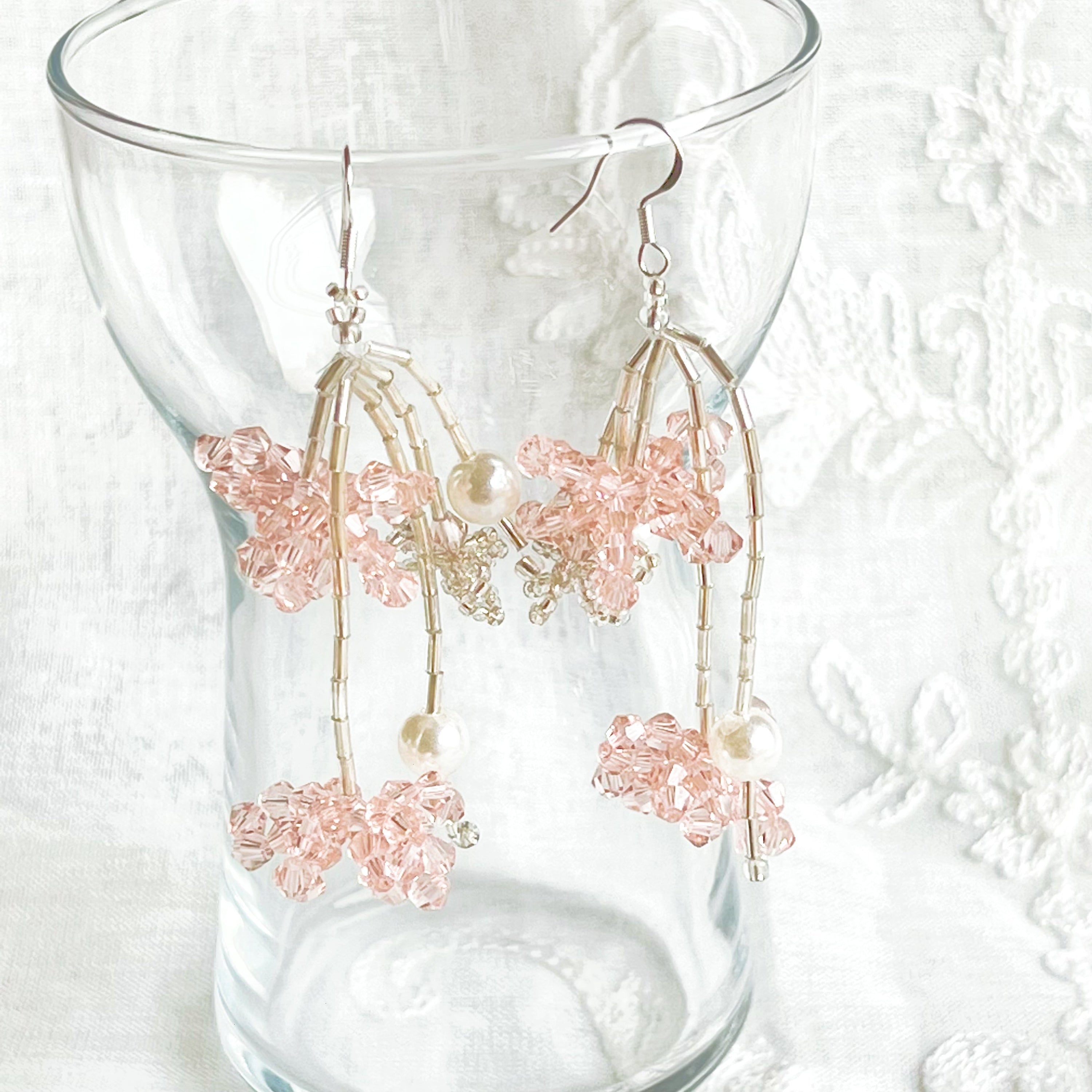 A pair of pink beaded flower statement earrings featuring vibrant acrylic beads and sterling silver ear wires, beautifully arranged in a gift box.