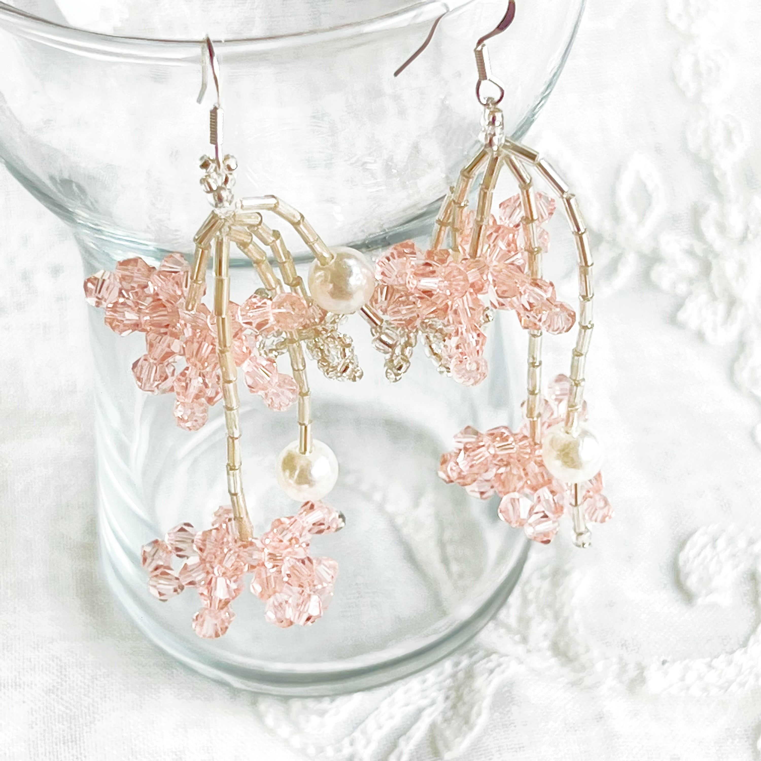 A pair of pink beaded flower statement earrings featuring vibrant acrylic beads and sterling silver ear wires, beautifully arranged in a gift box.